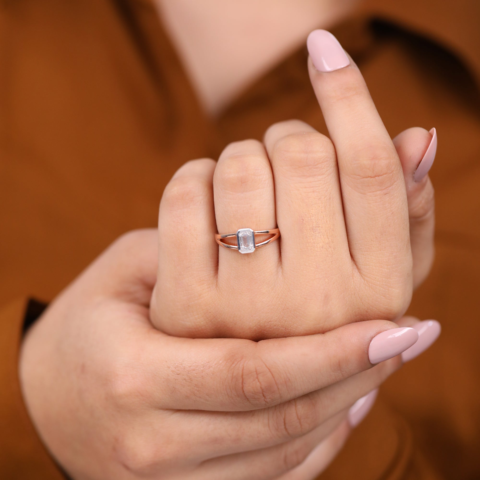 Bezel set emerald cut lab grown diamond ring with clean, open band design