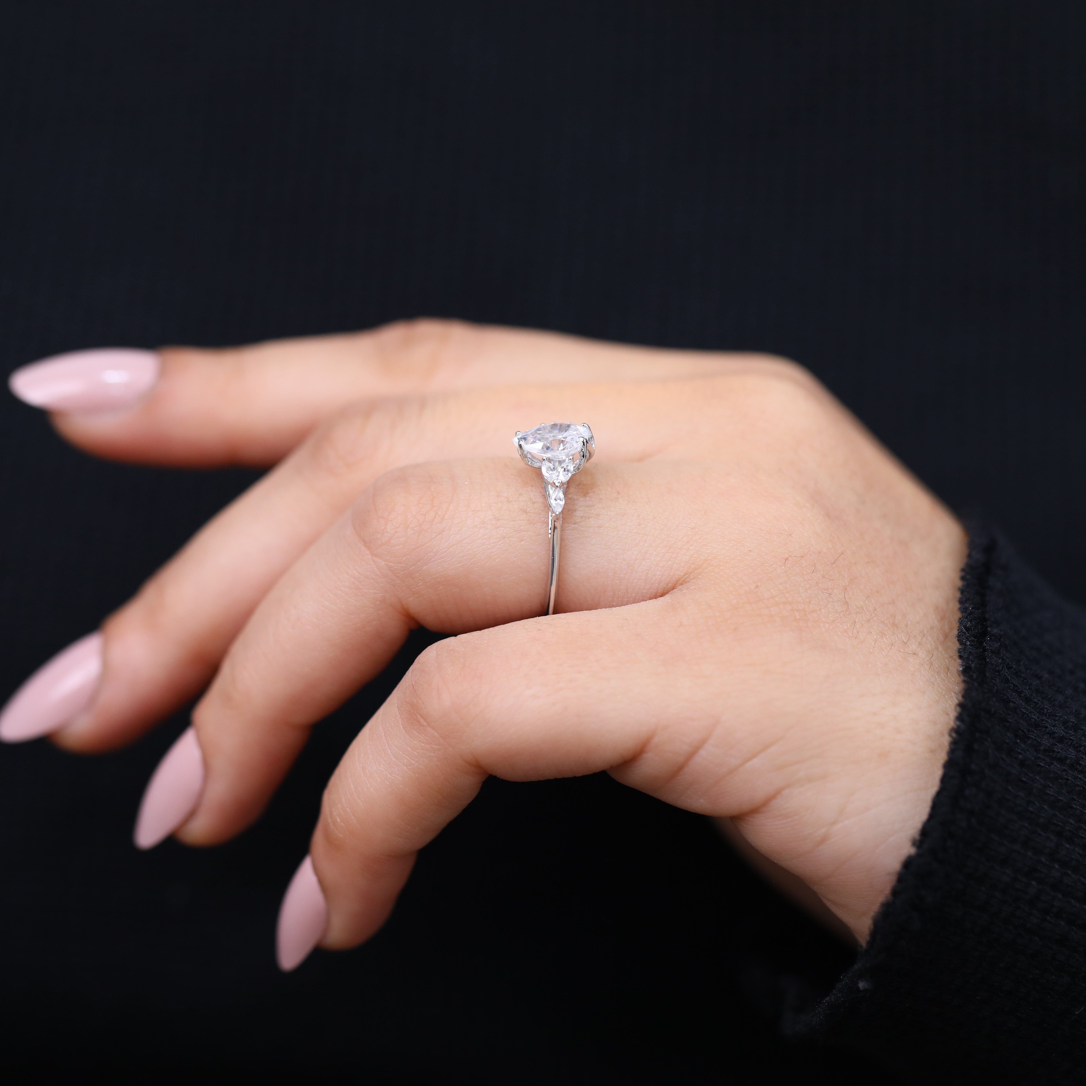 Delicate pear cut lab grown diamond ring with marquise accent stones.