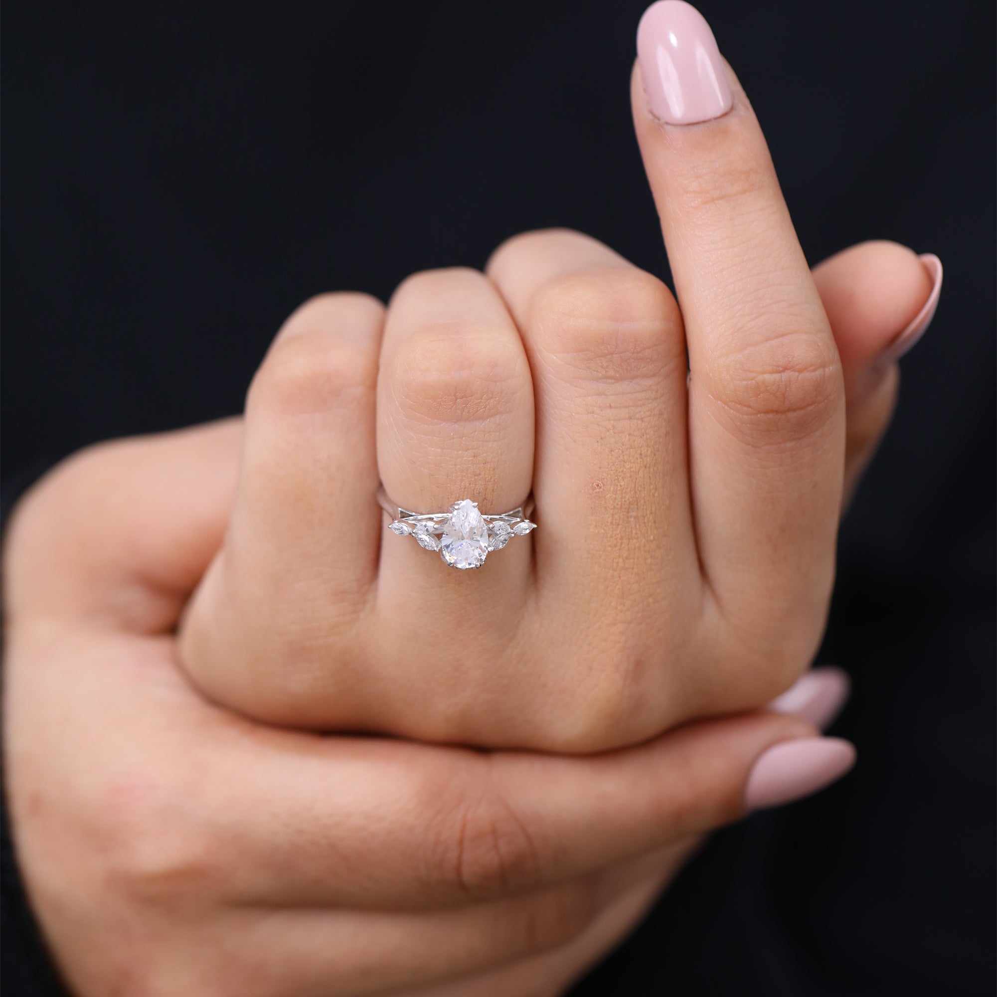 Pear shaped lab diamond engagement ring featuring marquise floral setting