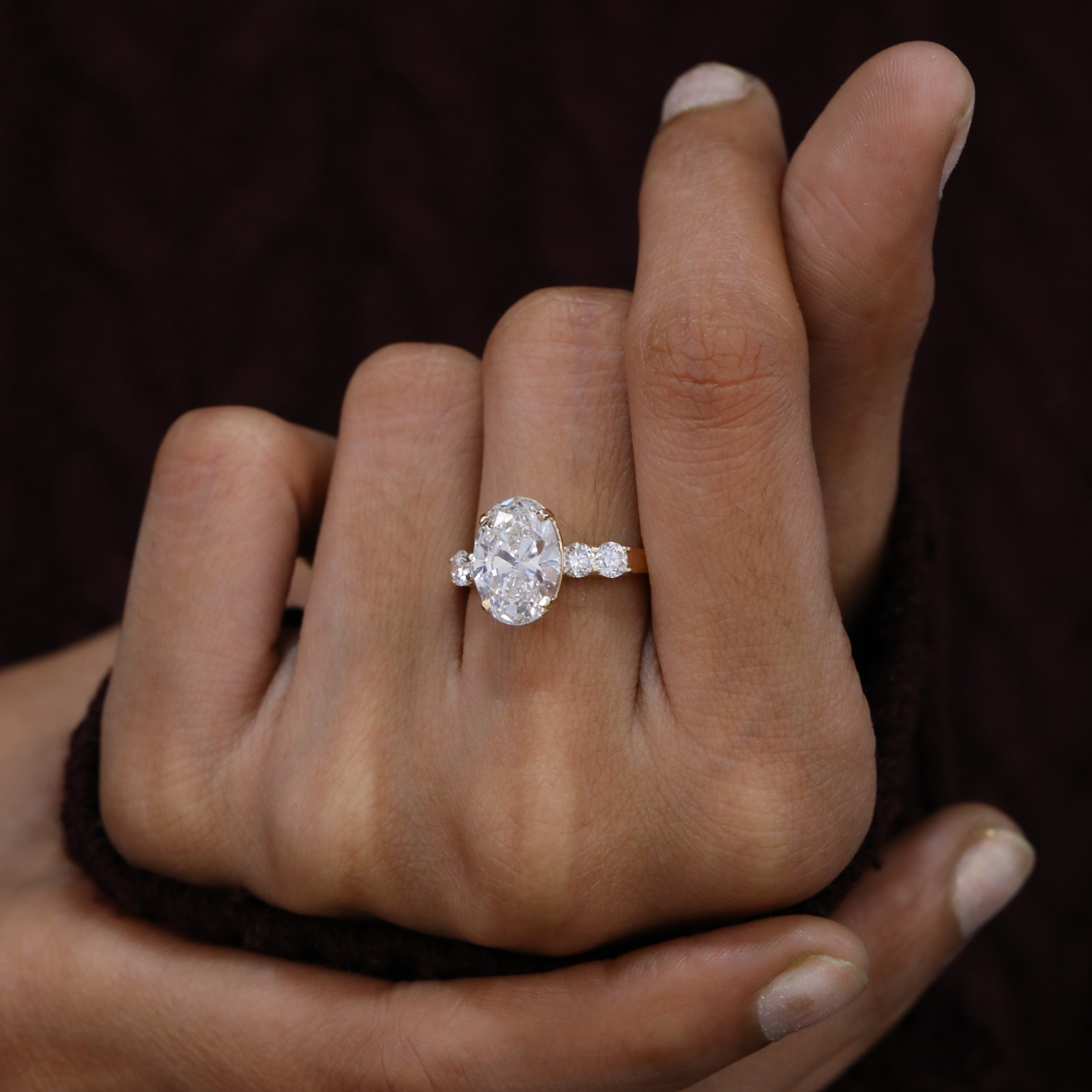 Elegant oval solitaire and side diamond anniversary ring