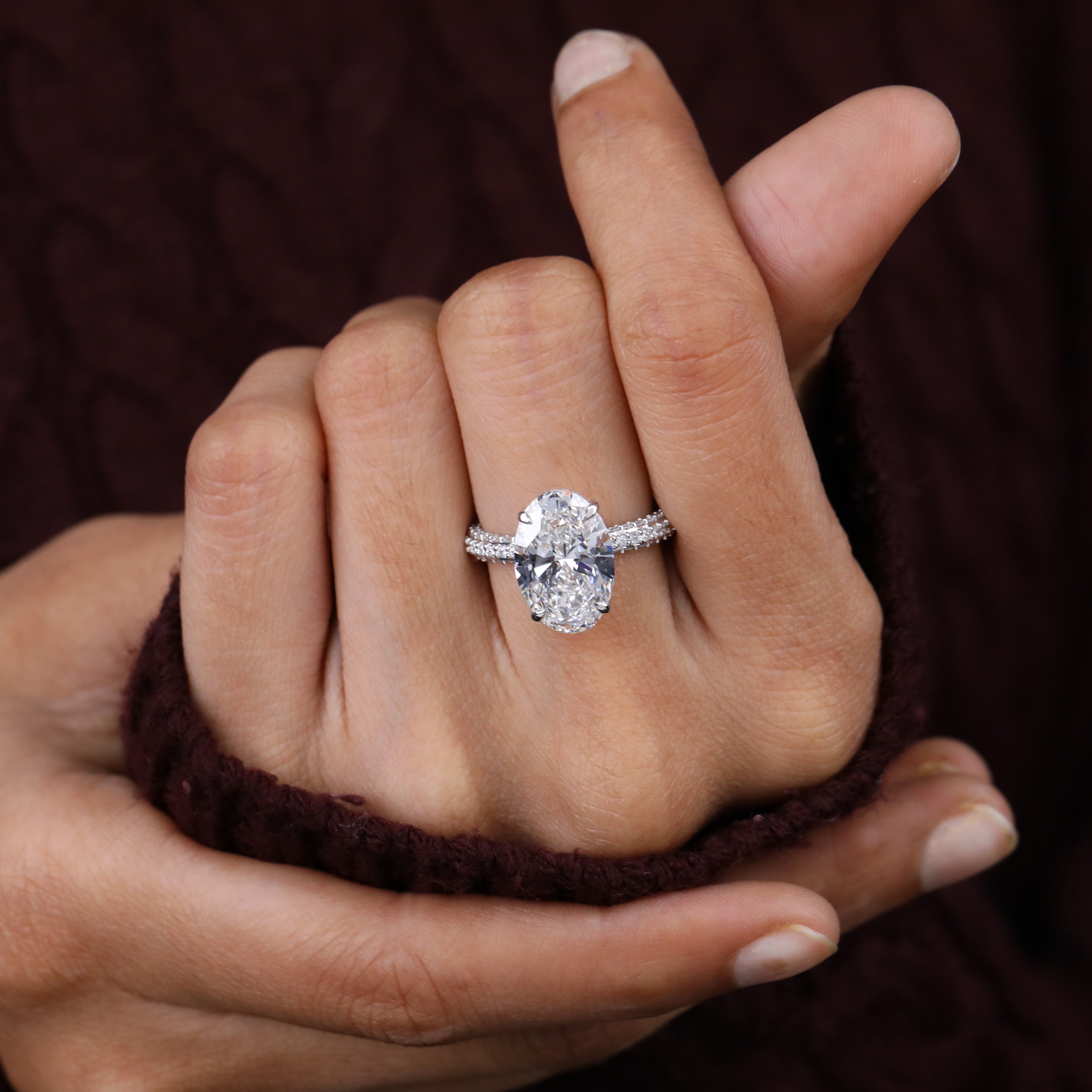 Oval solitaire ring showcasing a brilliant lab grown diamond and pavé accents