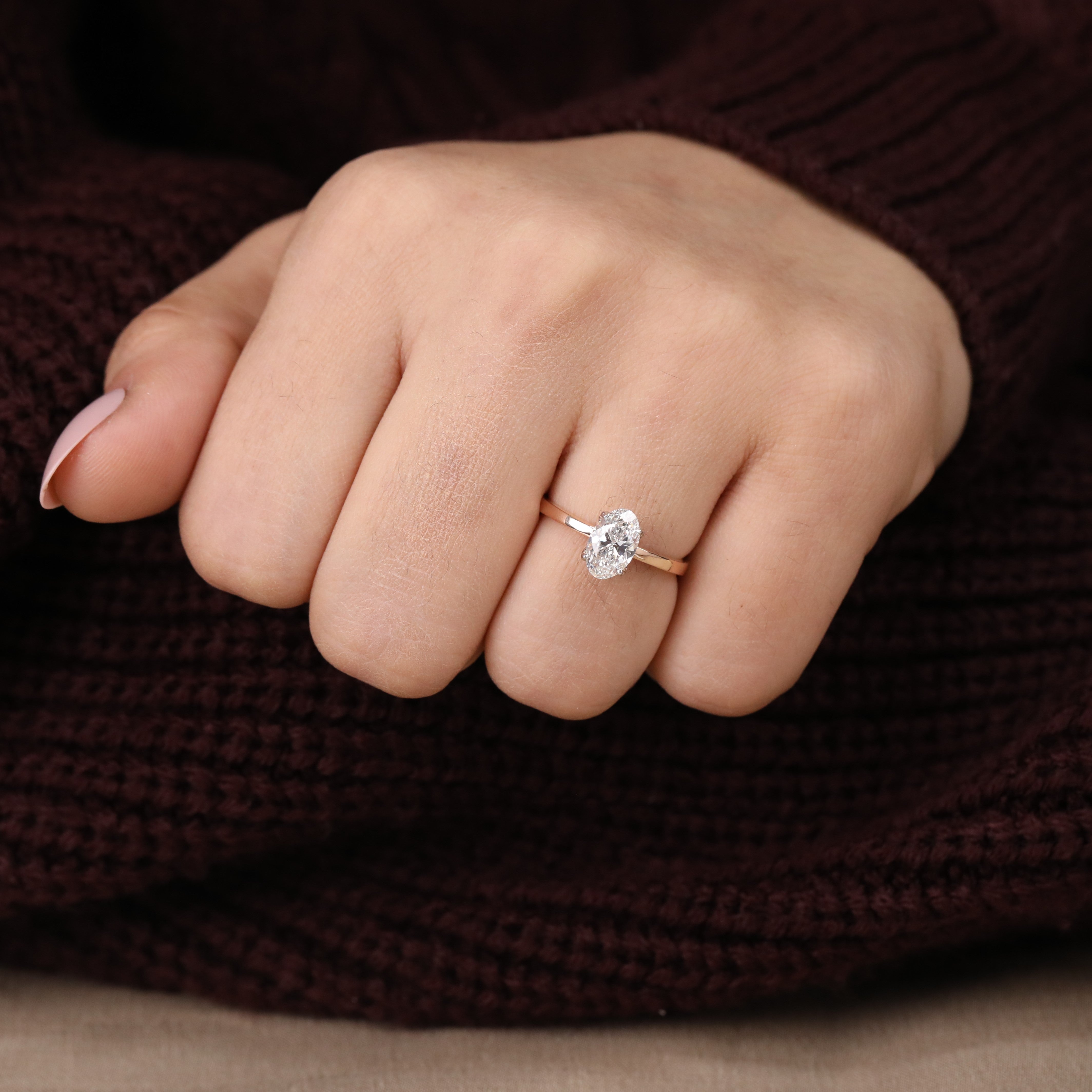 Refined engagement ring showcasing a bright oval lab grown diamond in prongs