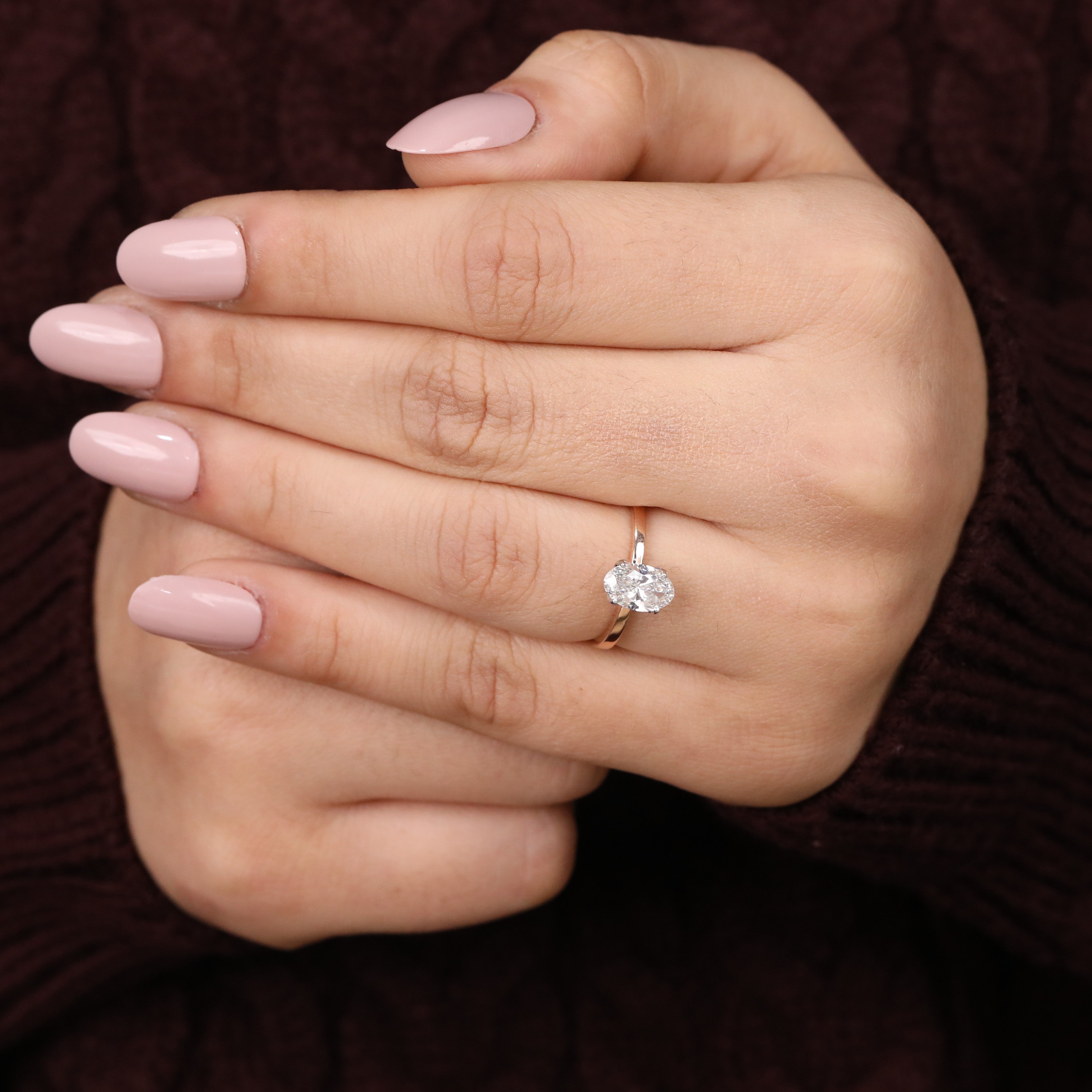 Sleek band ring featuring a brilliant oval lab grown diamond centerpiece