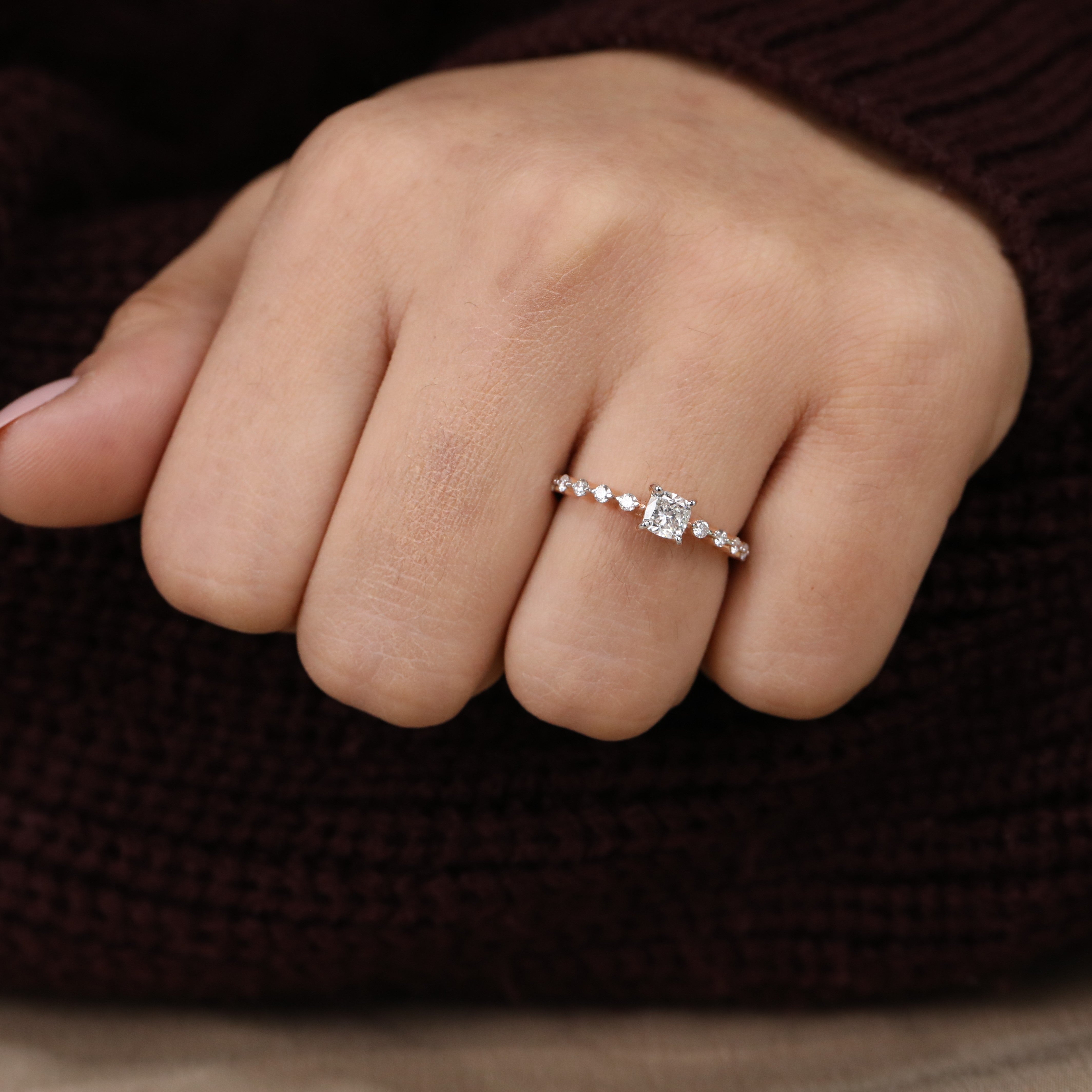 Side-stone engagement ring showcasing a Cushion cut lab grown diamond centerpiece