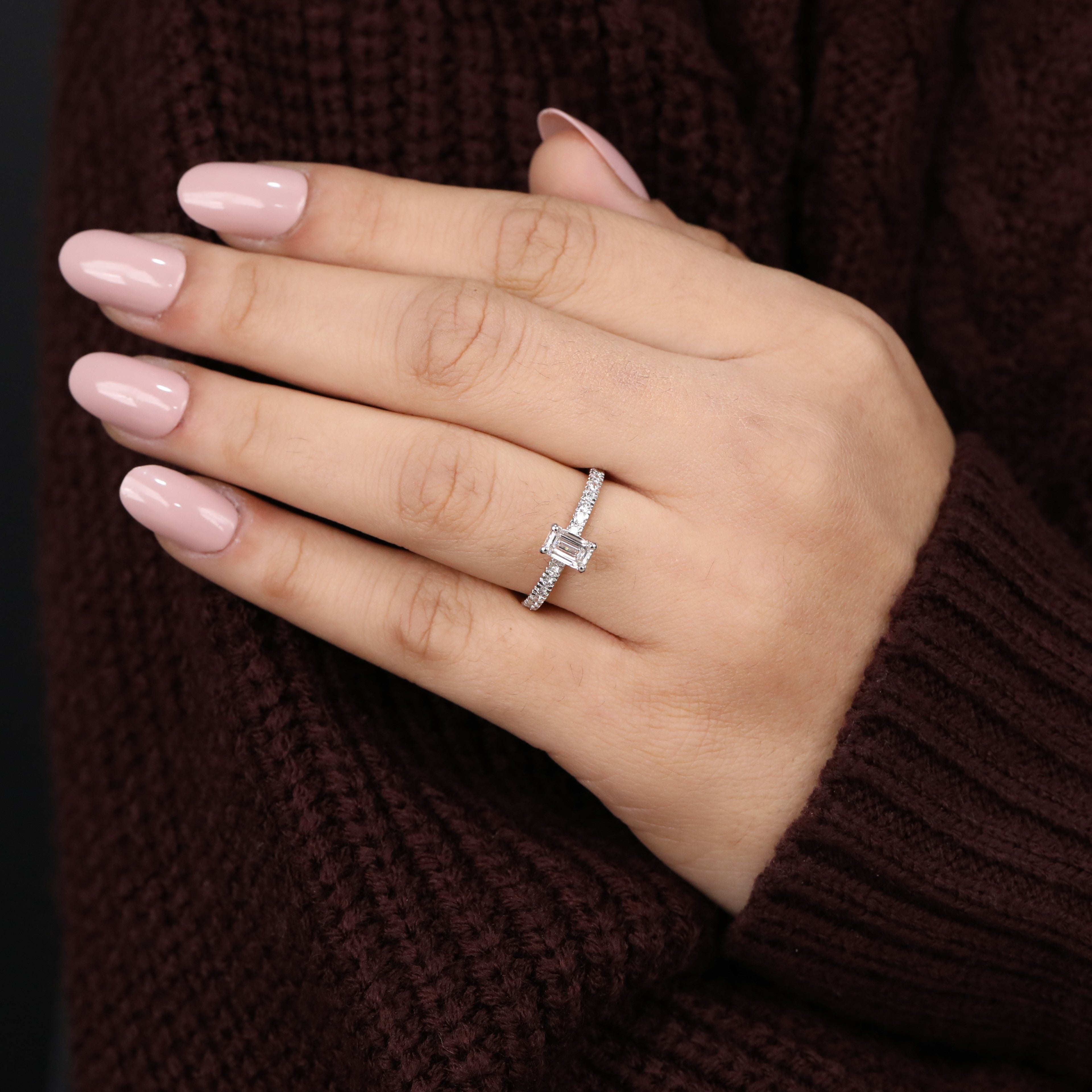 Modern emerald cut solitaire ring set on a pavé rose gold band
