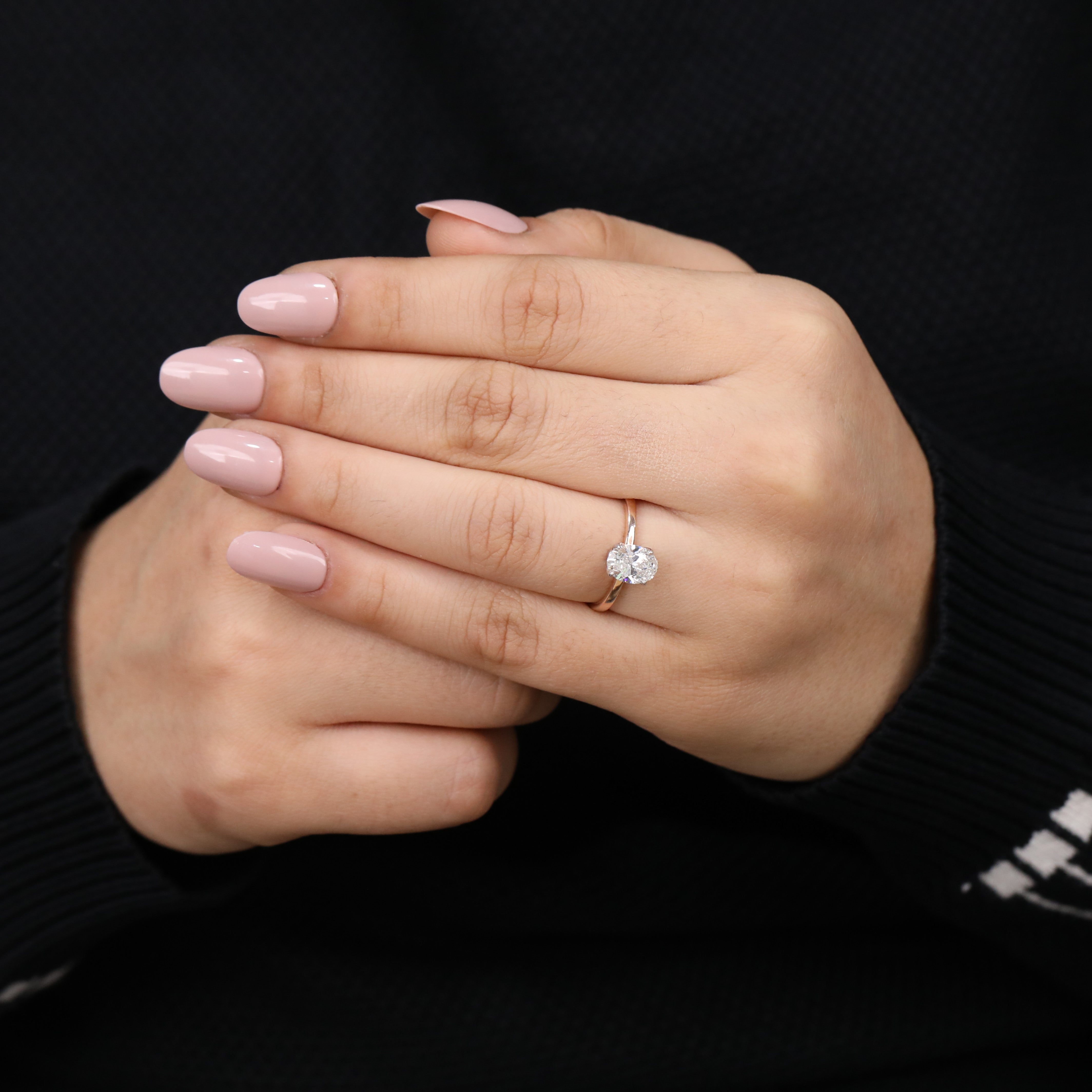 Sleek band ring featuring a brilliant oval lab grown diamond centerpiece.