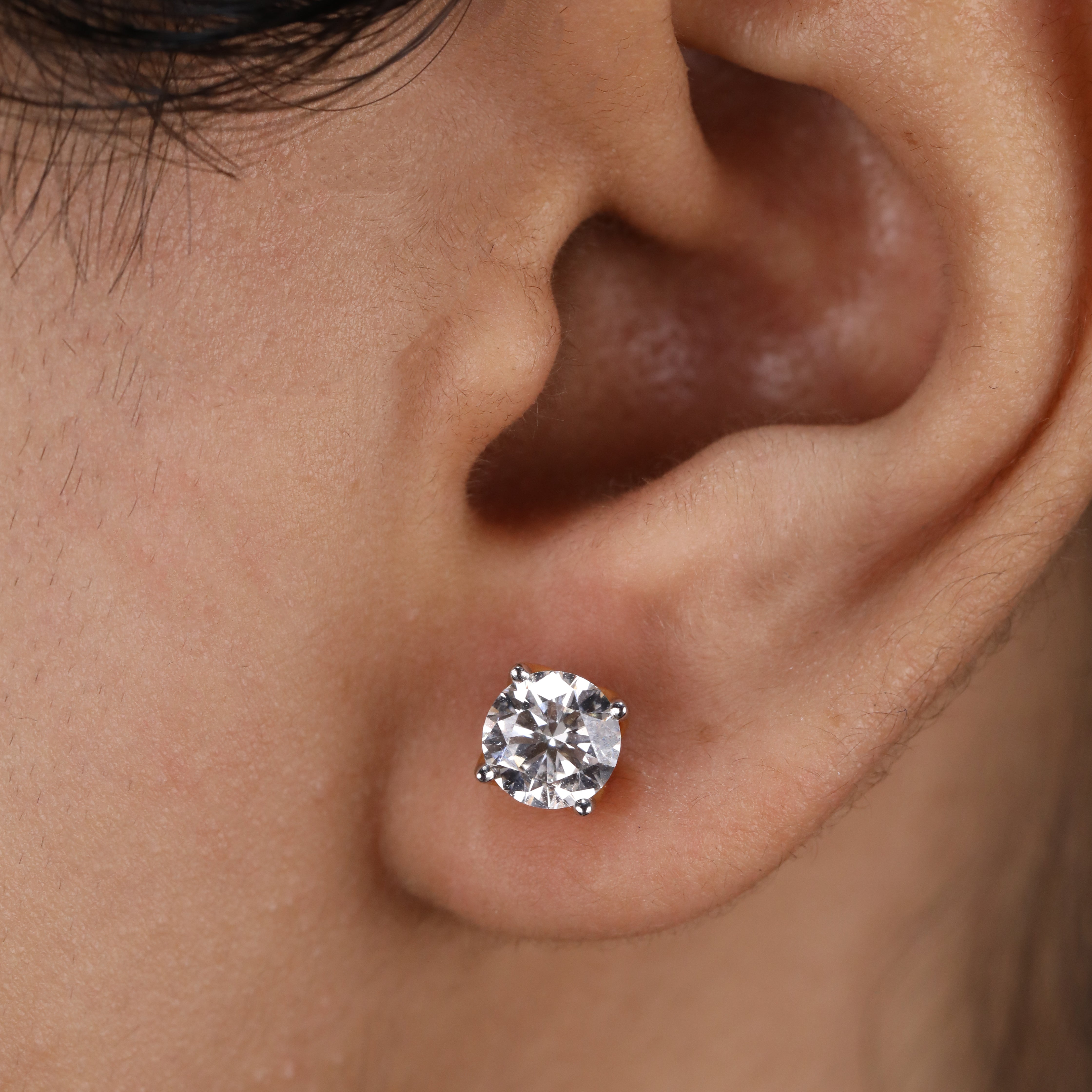 Round diamond stud earrings crafted for party wear or celebrations.