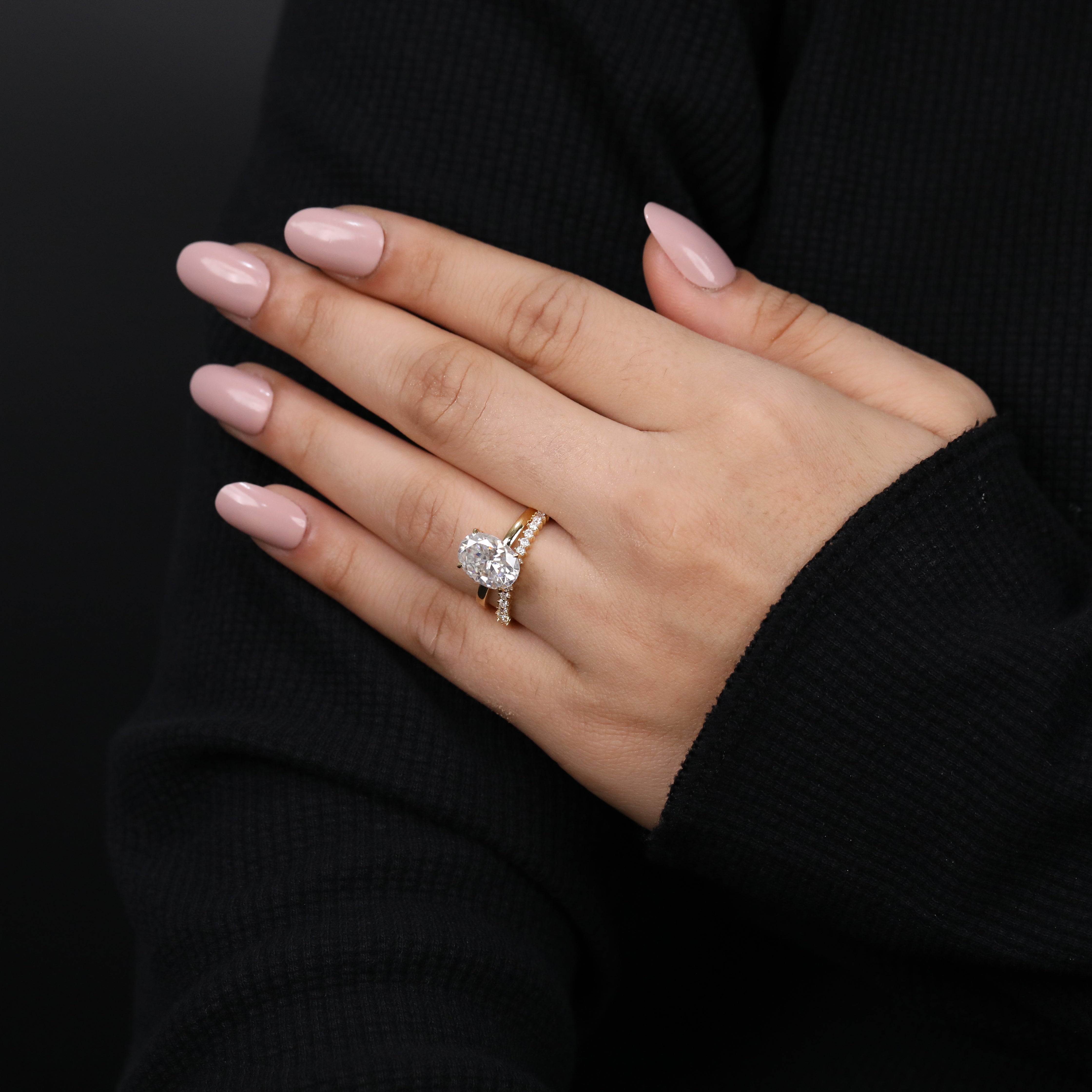 Oval lab diamond engagement ring with coordinating pavé wedding ring.