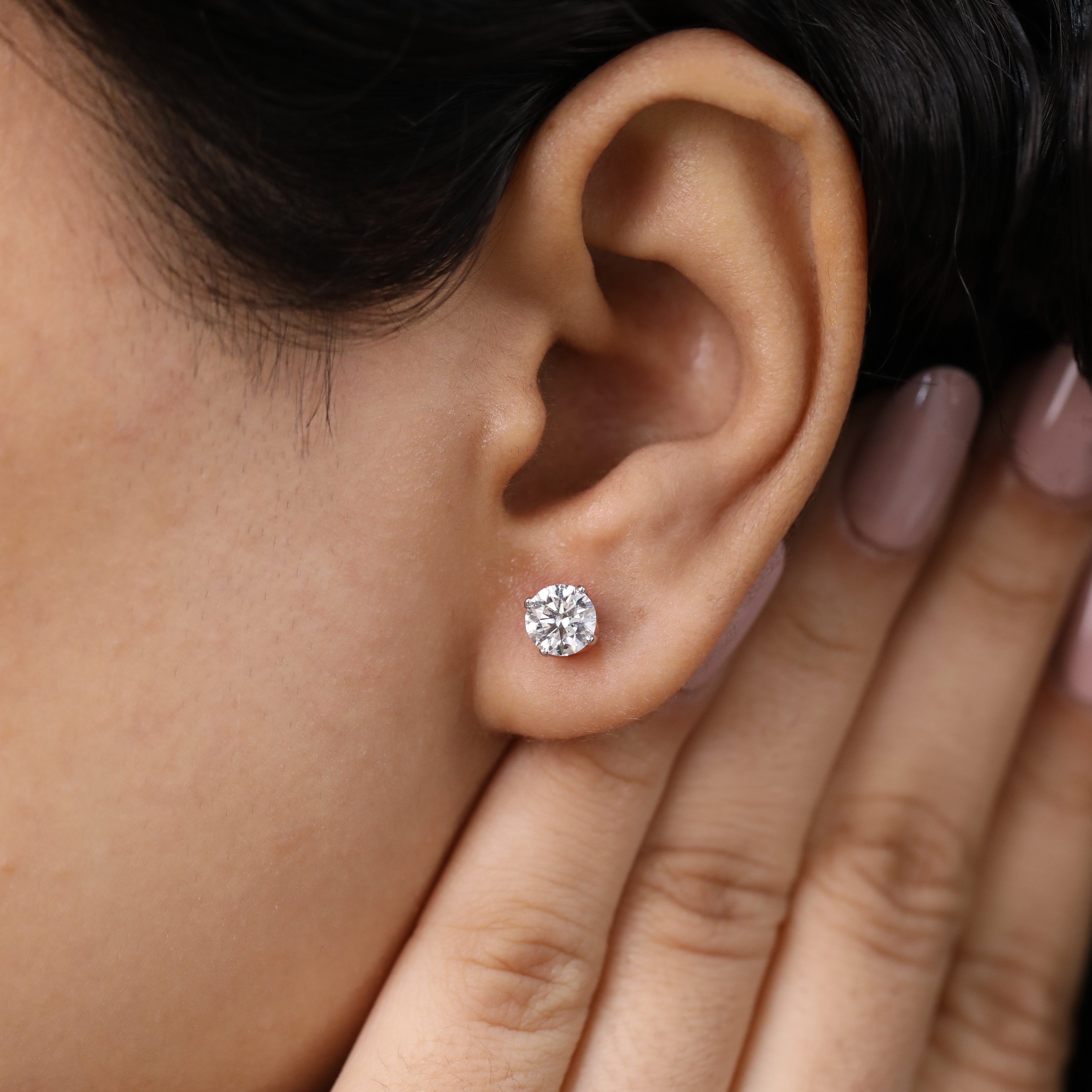 Dainty round-cut diamond studs crafted for graduation gifts and daily use