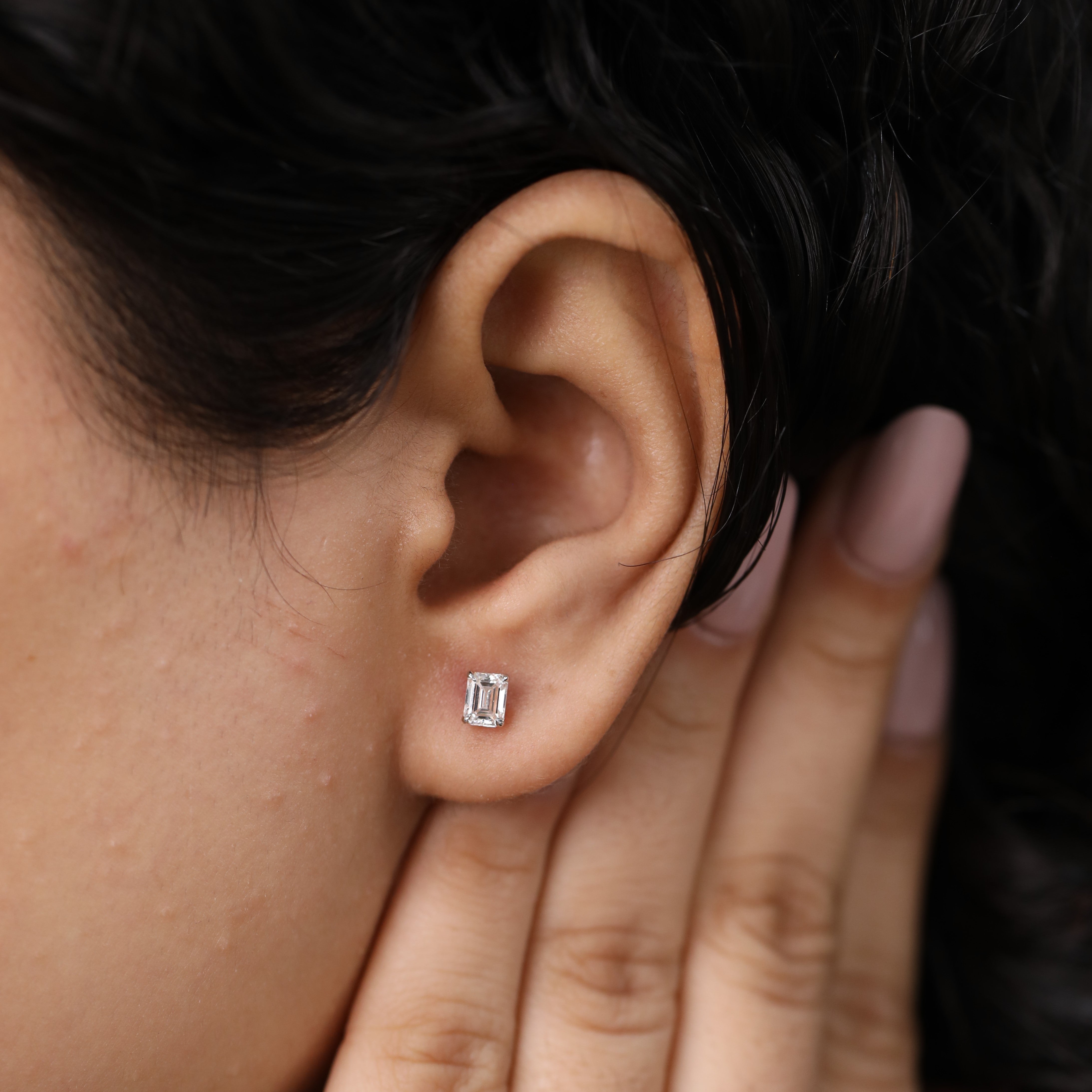 Sparkling emerald cut diamond studs perfect for wedding and festive looks.