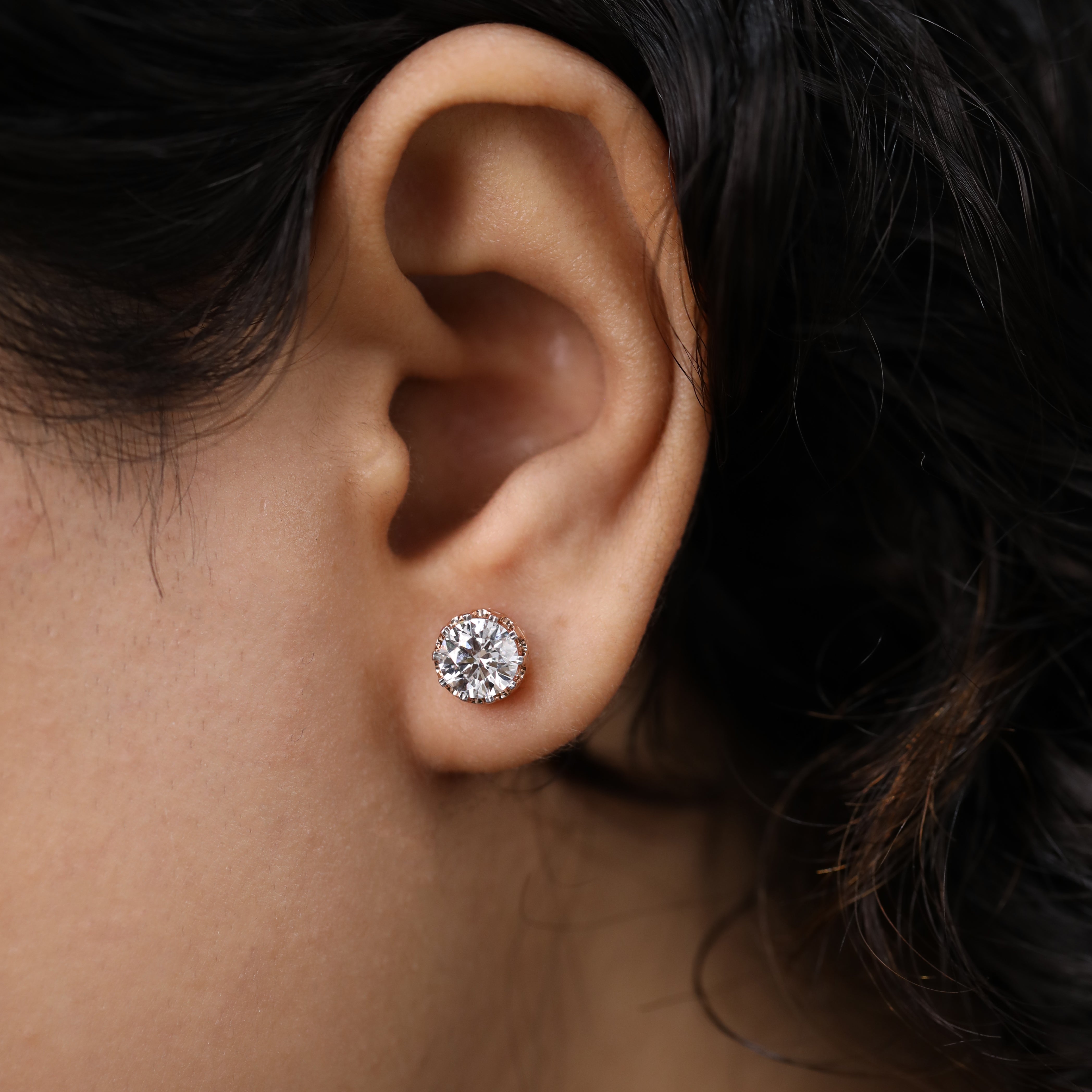 Stylish round-cut diamond studs ideal for wedding and festive looks.