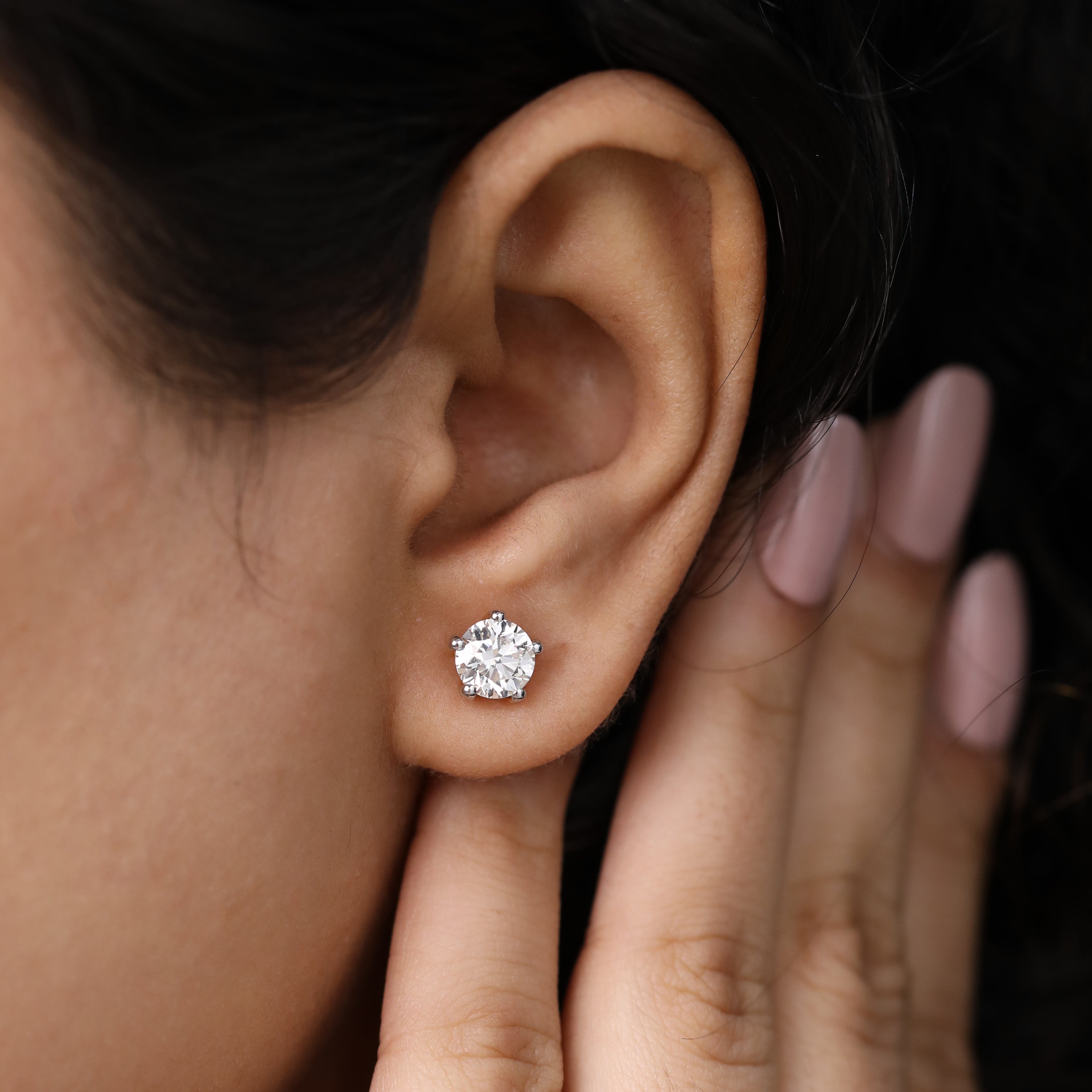 Radiant round diamond earrings ideal for engagement or anniversary gifting.