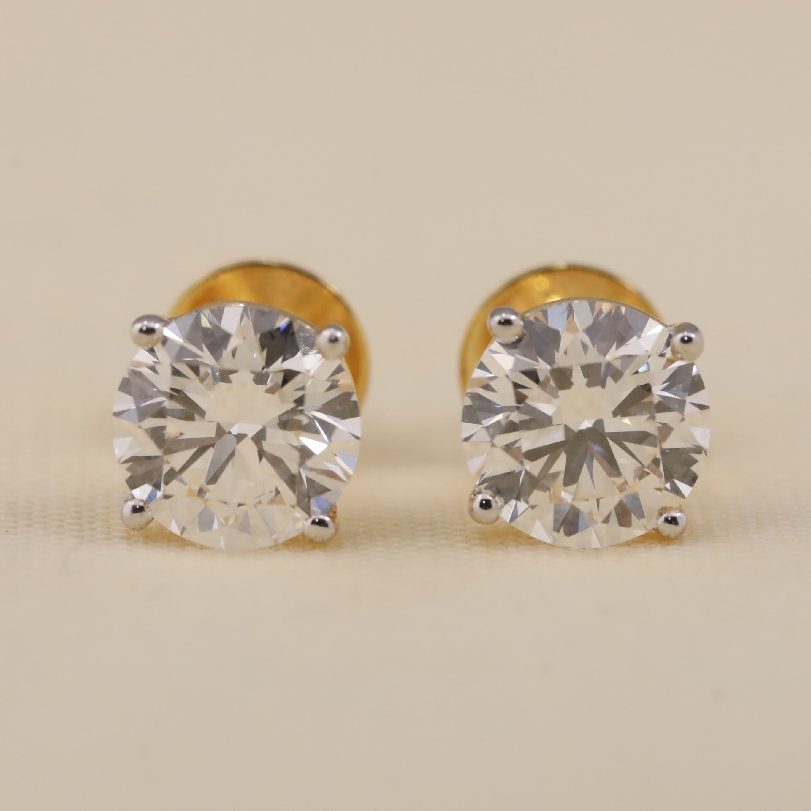 A pair of round lab grown diamond stud earrings designed for wedding day elegance