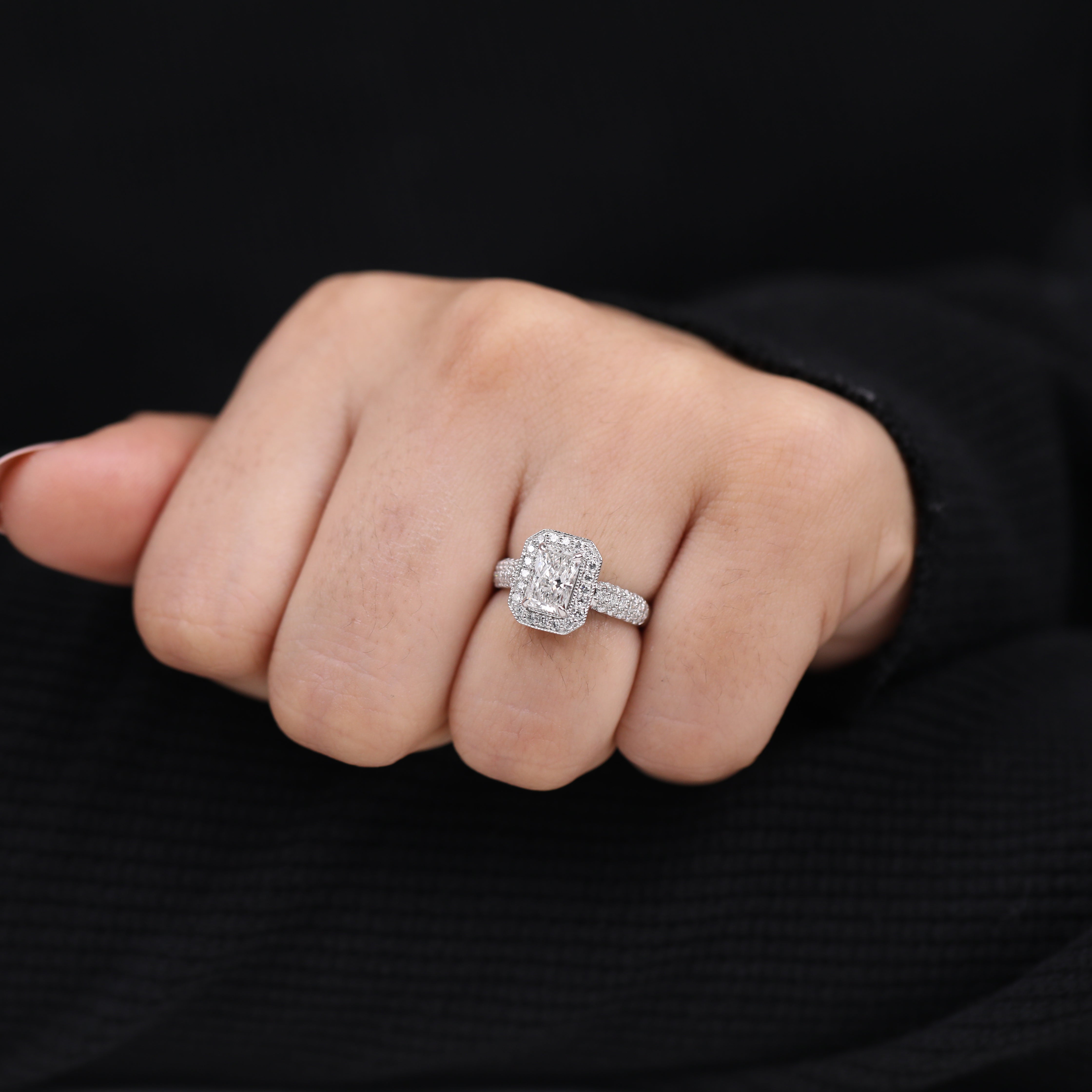 Emerald cut lab diamond engagement ring with a refined halo setting.