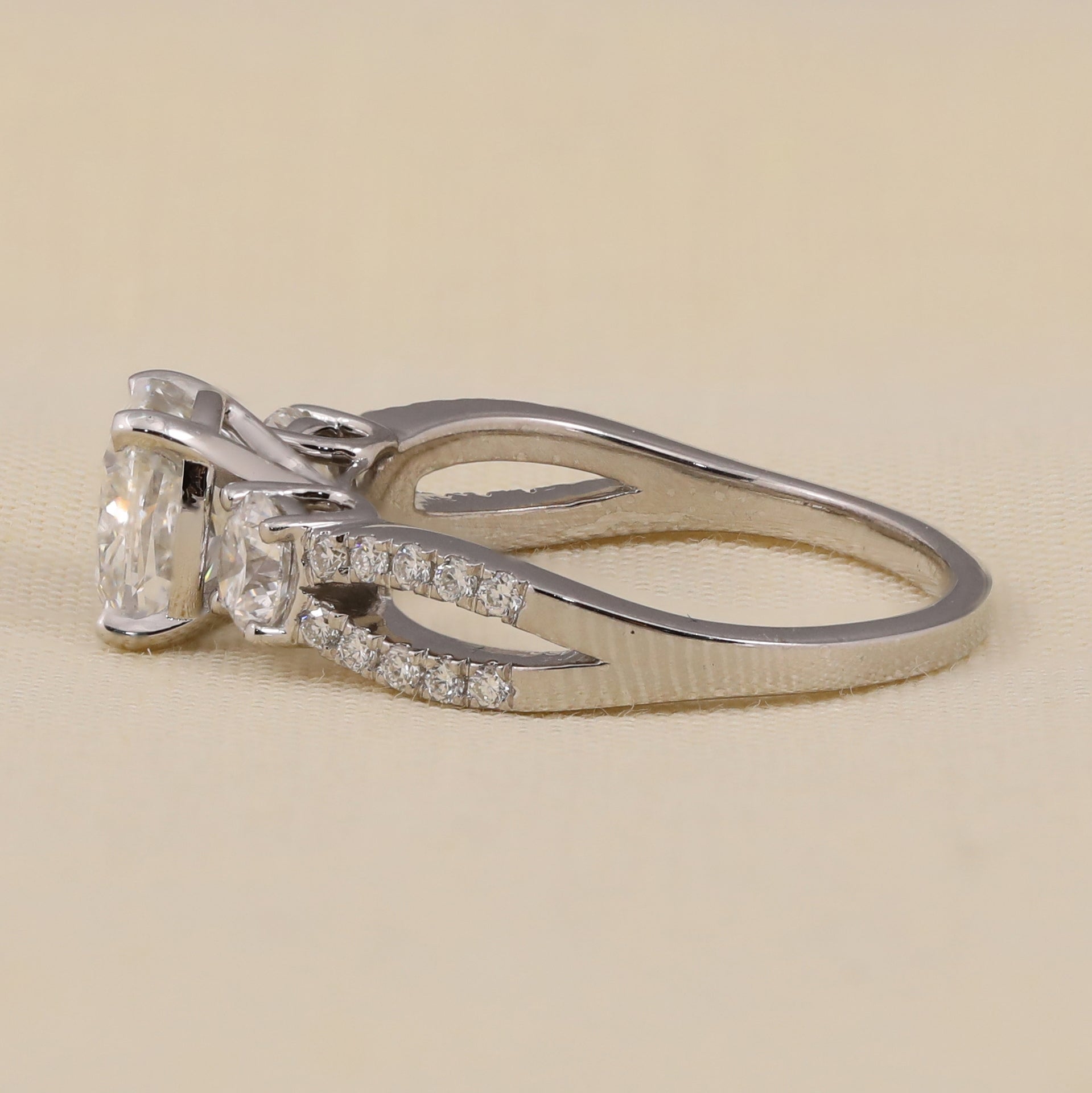 Cushion cut lab diamond engagement ring featuring diamond accented shoulders