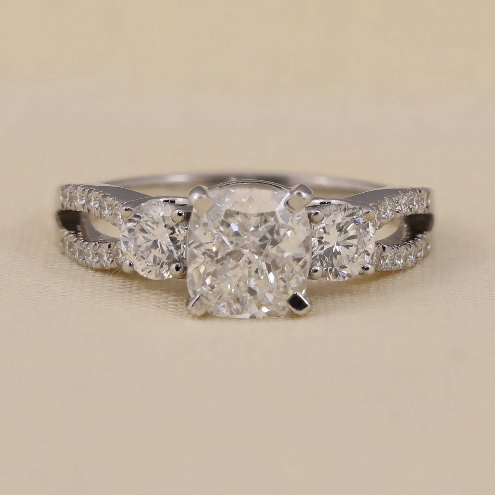 Cushion cut lab diamond engagement ring with split shank and side diamonds
