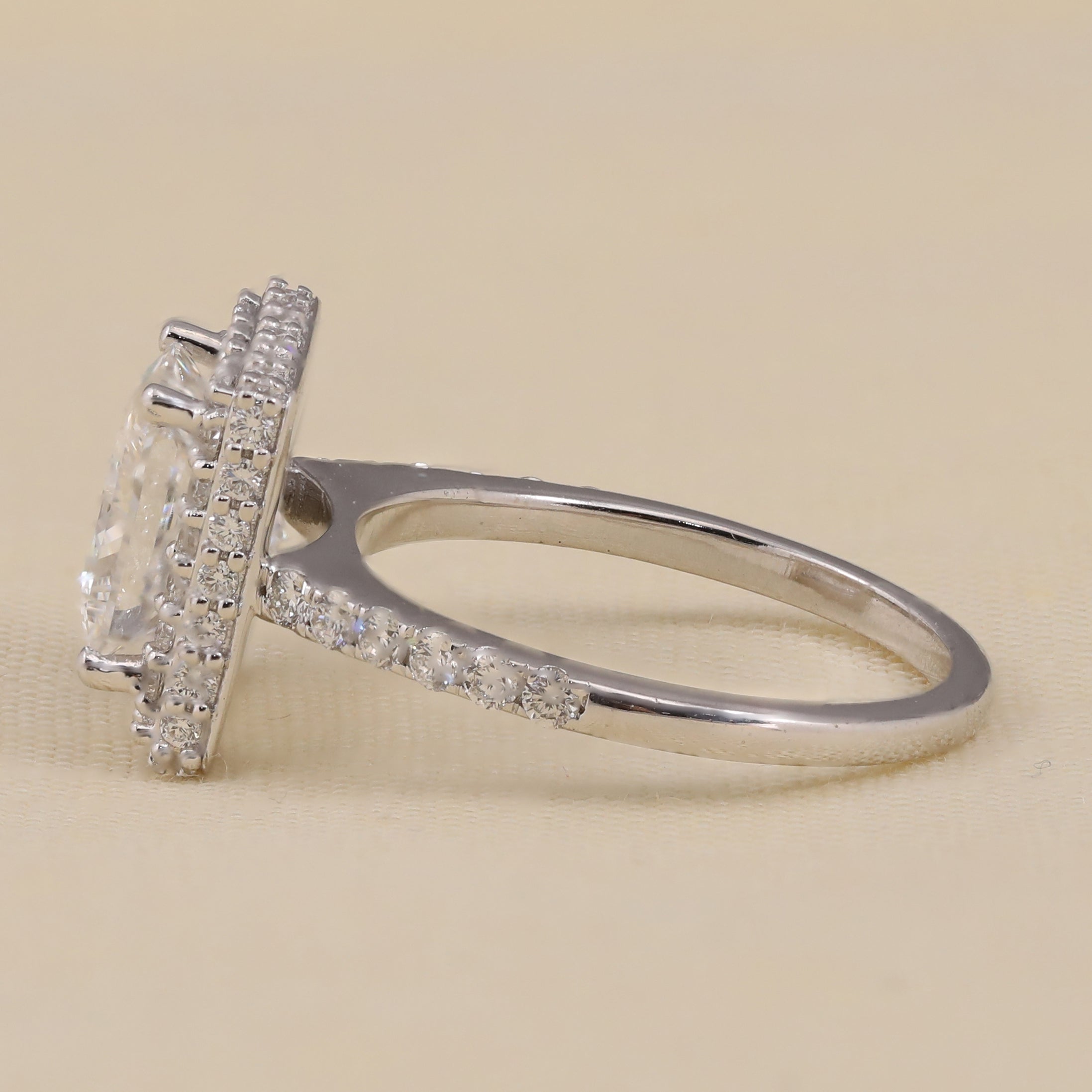 Halo engagement ring showcasing a princess cut lab diamond center stone.