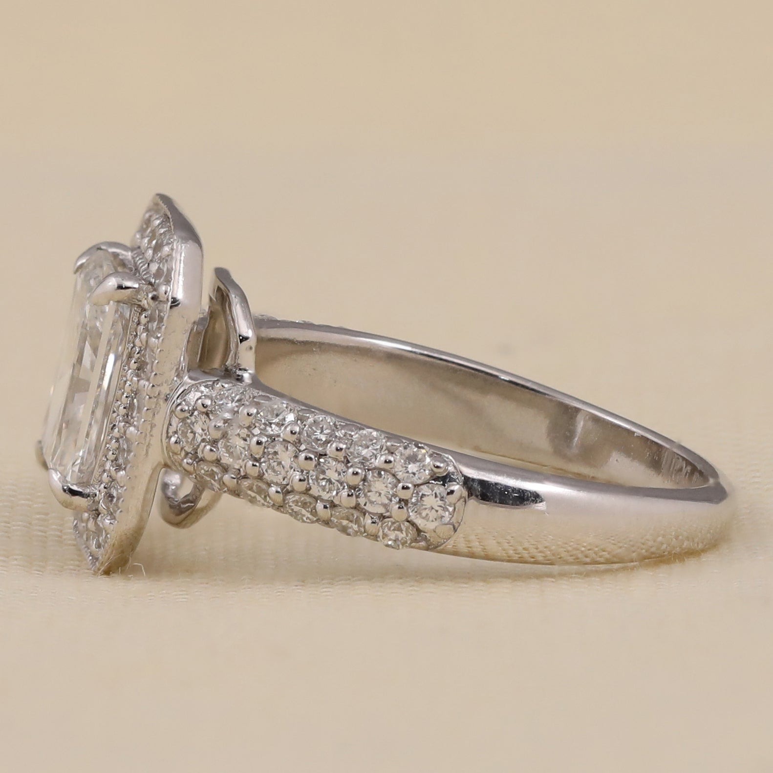 Halo engagement ring showcasing an emerald cut lab diamond center stone