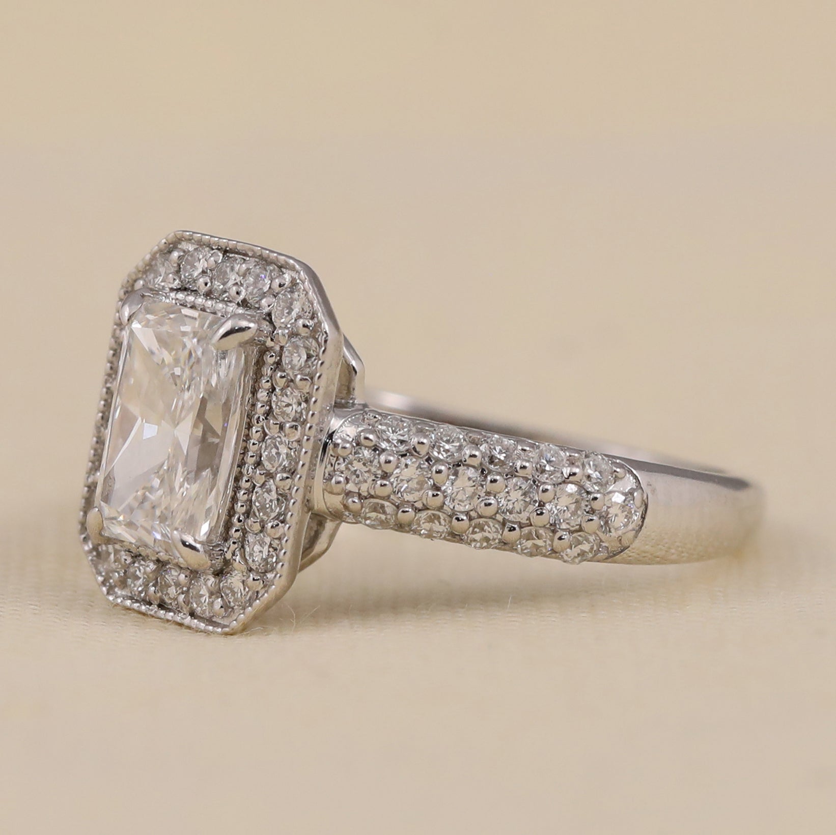 Emerald cut lab diamond halo ring with a sparkling pavé band.