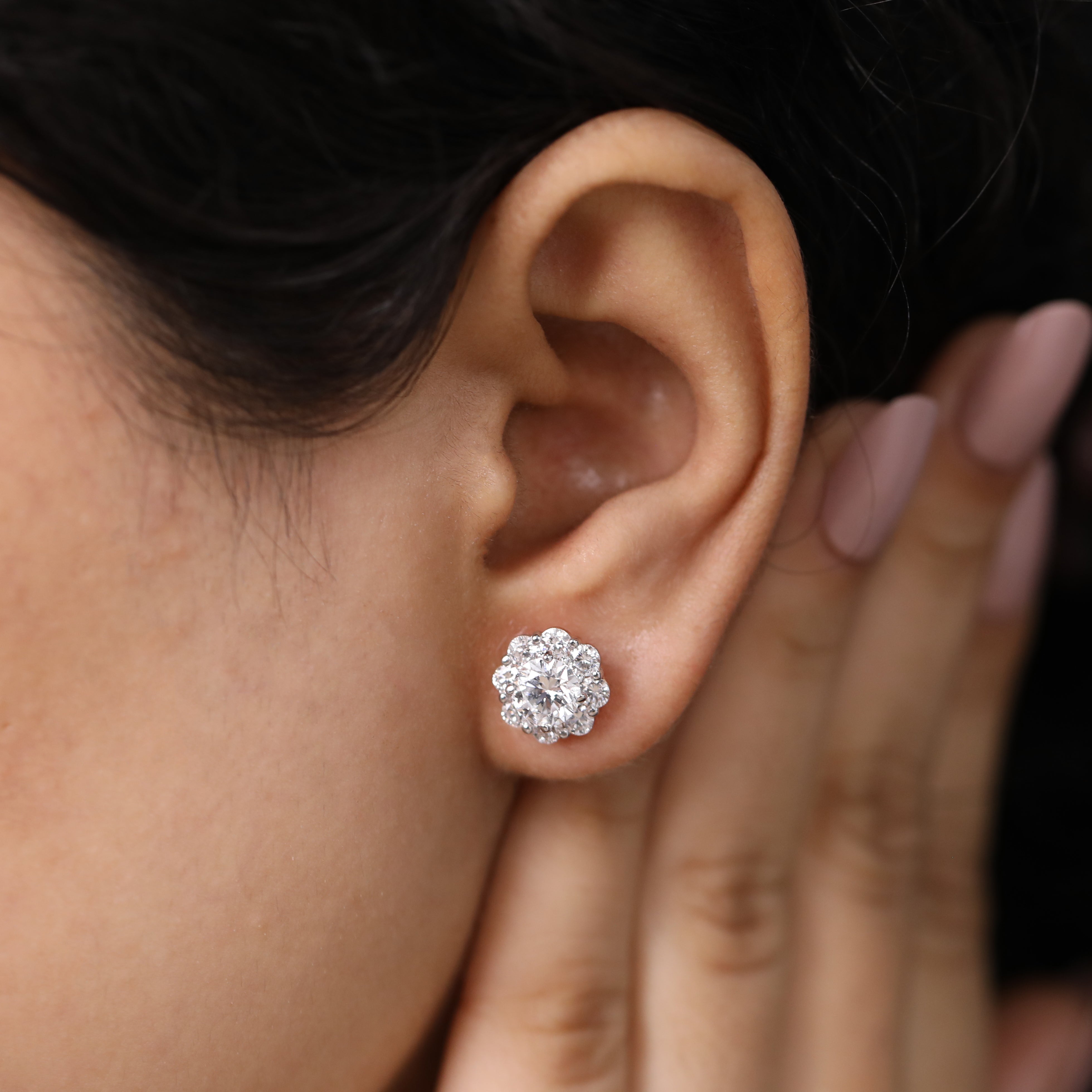 Beautiful round halo diamond studs styled for sophisticated anniversary looks