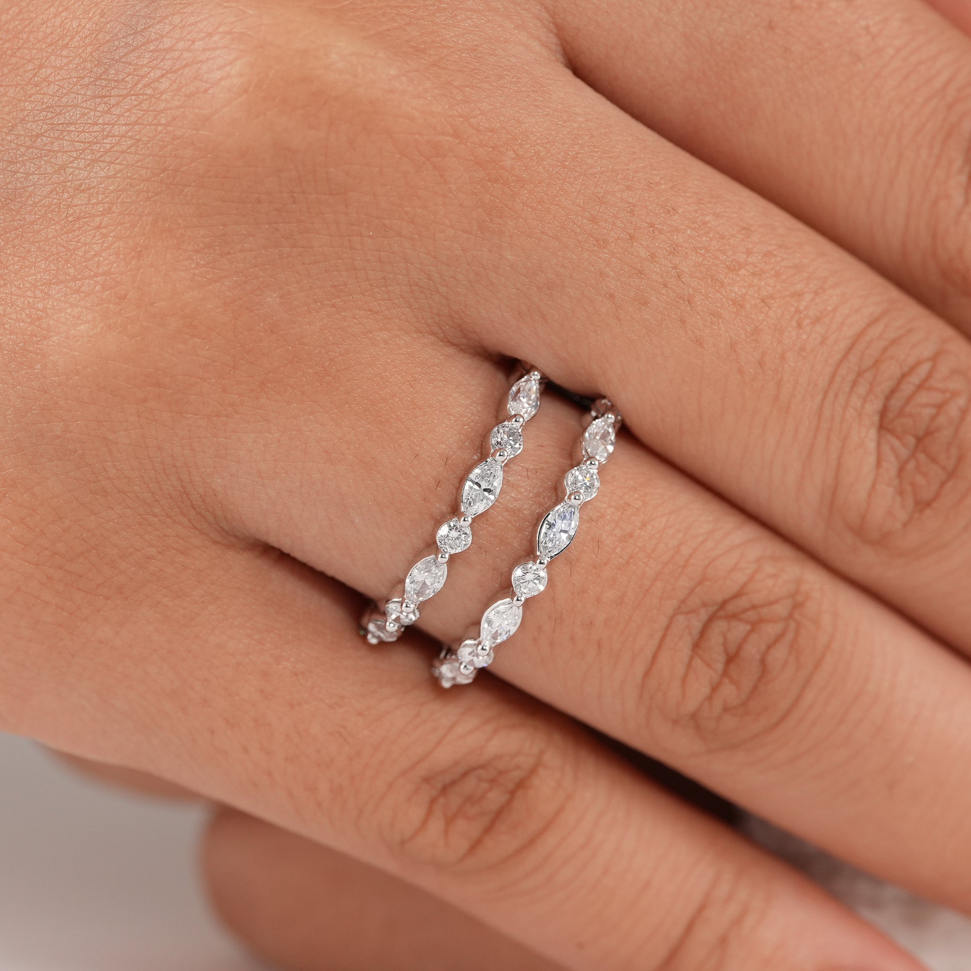Women's curved wedding band featuring round and marquise lab diamonds.