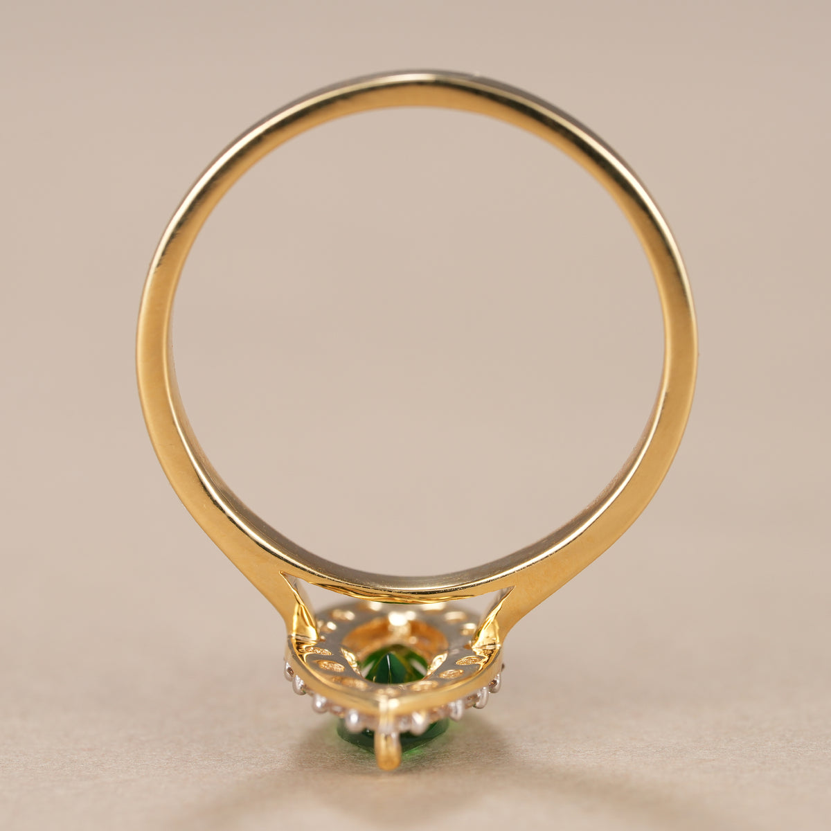 Vintage inspired emerald halo ring crafted in solid yellow gold with brilliant diamonds.