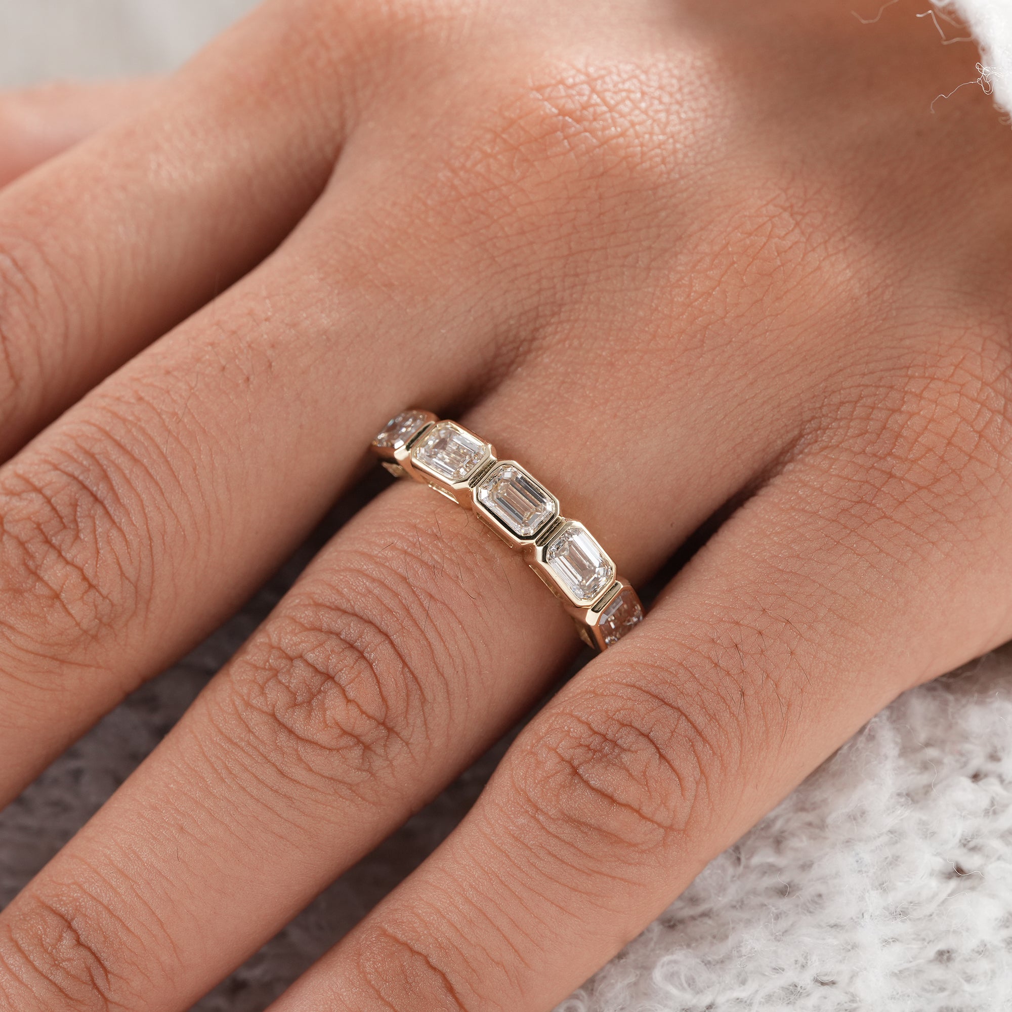 Sustainable emerald diamond anniversary band.