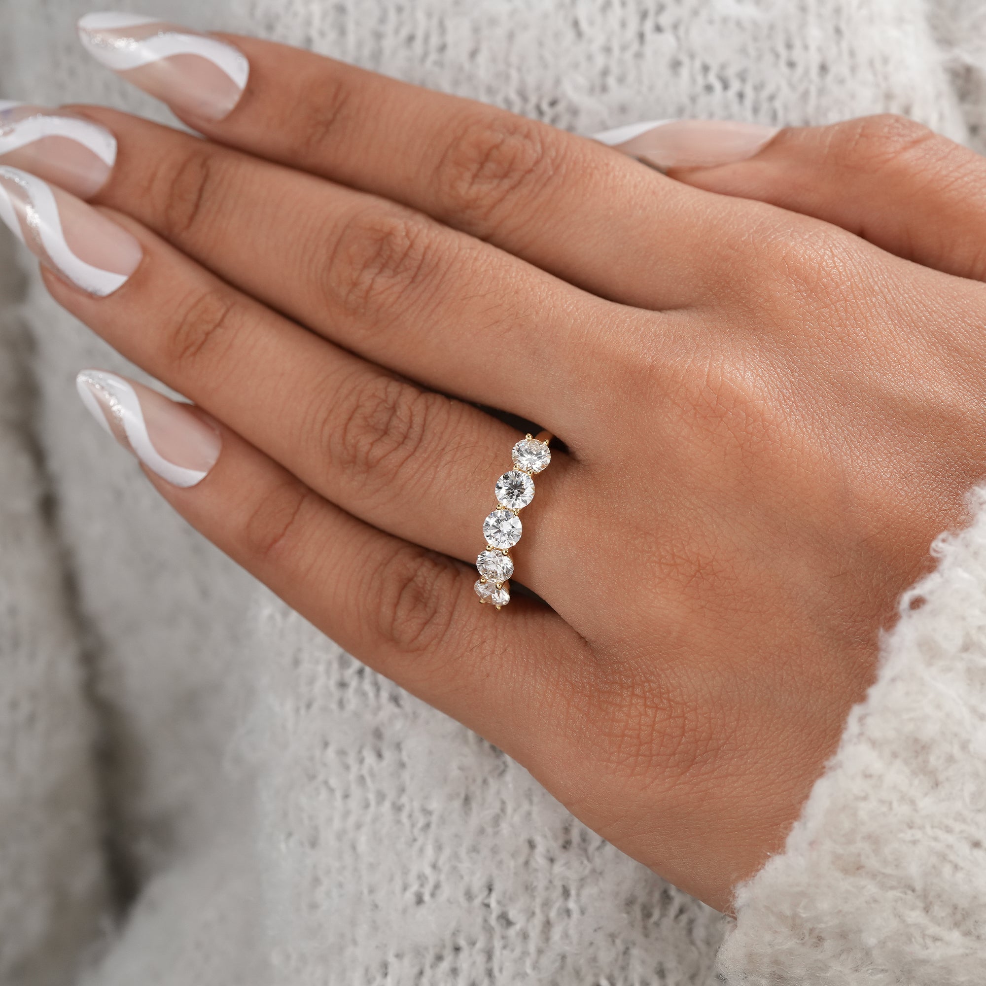 Fine jewelry five stone diamond ring with shared prong setting.