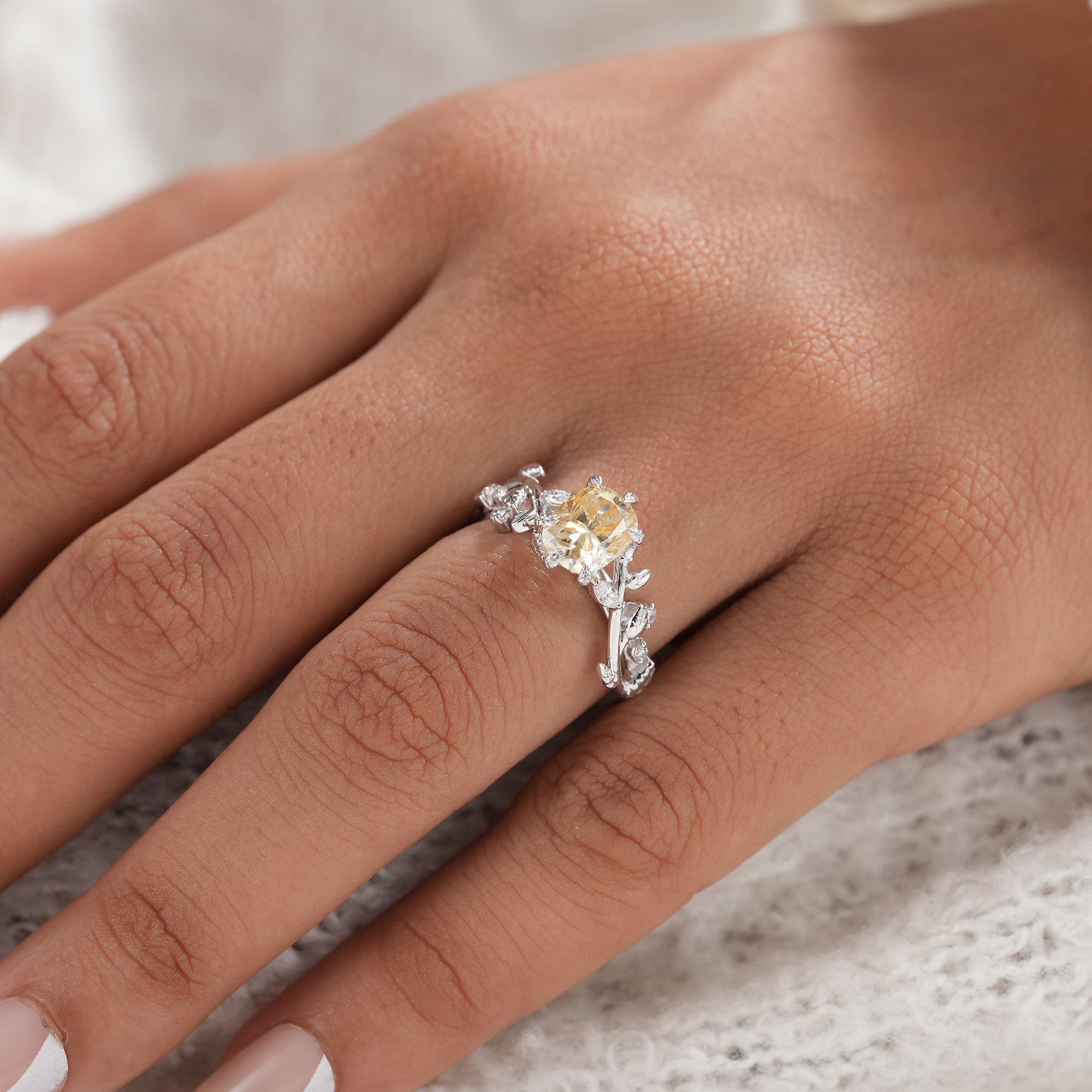 Luxury botanical engagement ring with yellow cushion diamond.
