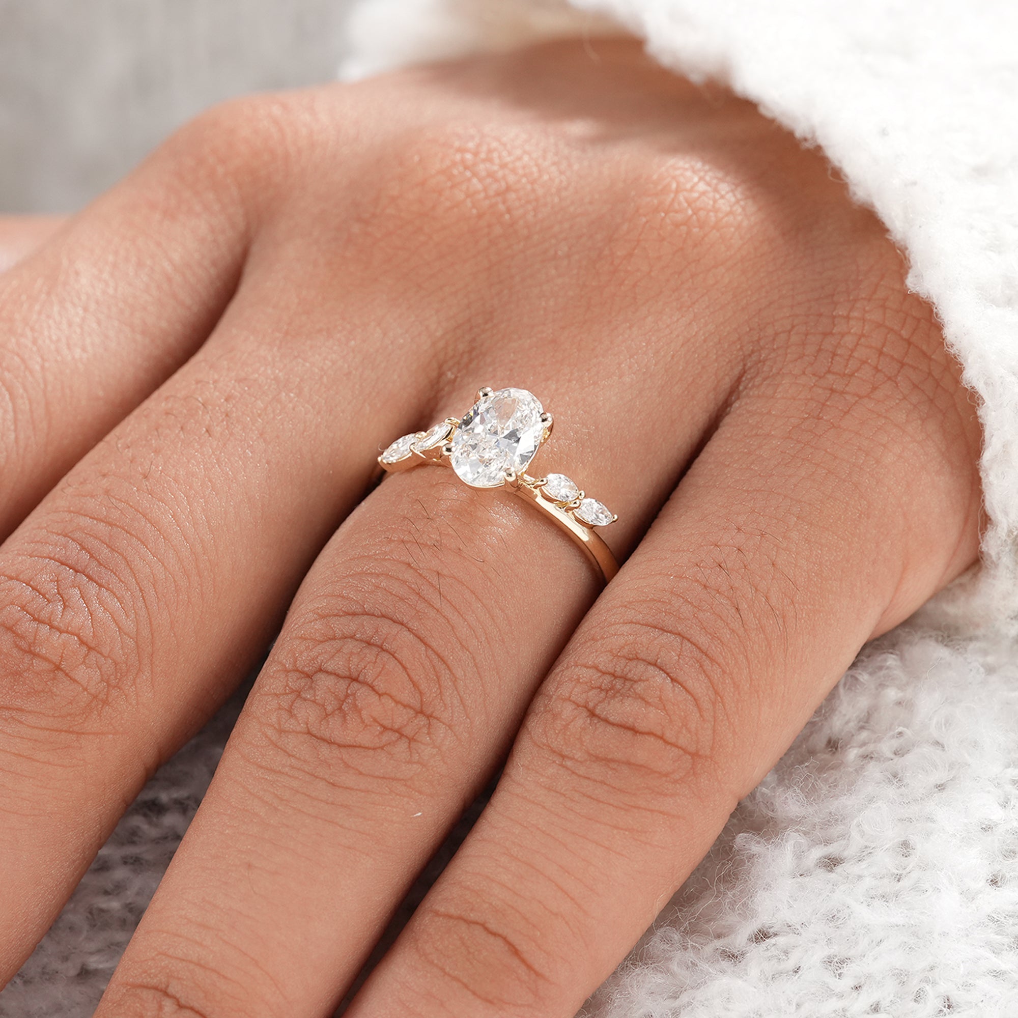 Sustainable oval diamond engagement ring in yellow gold.