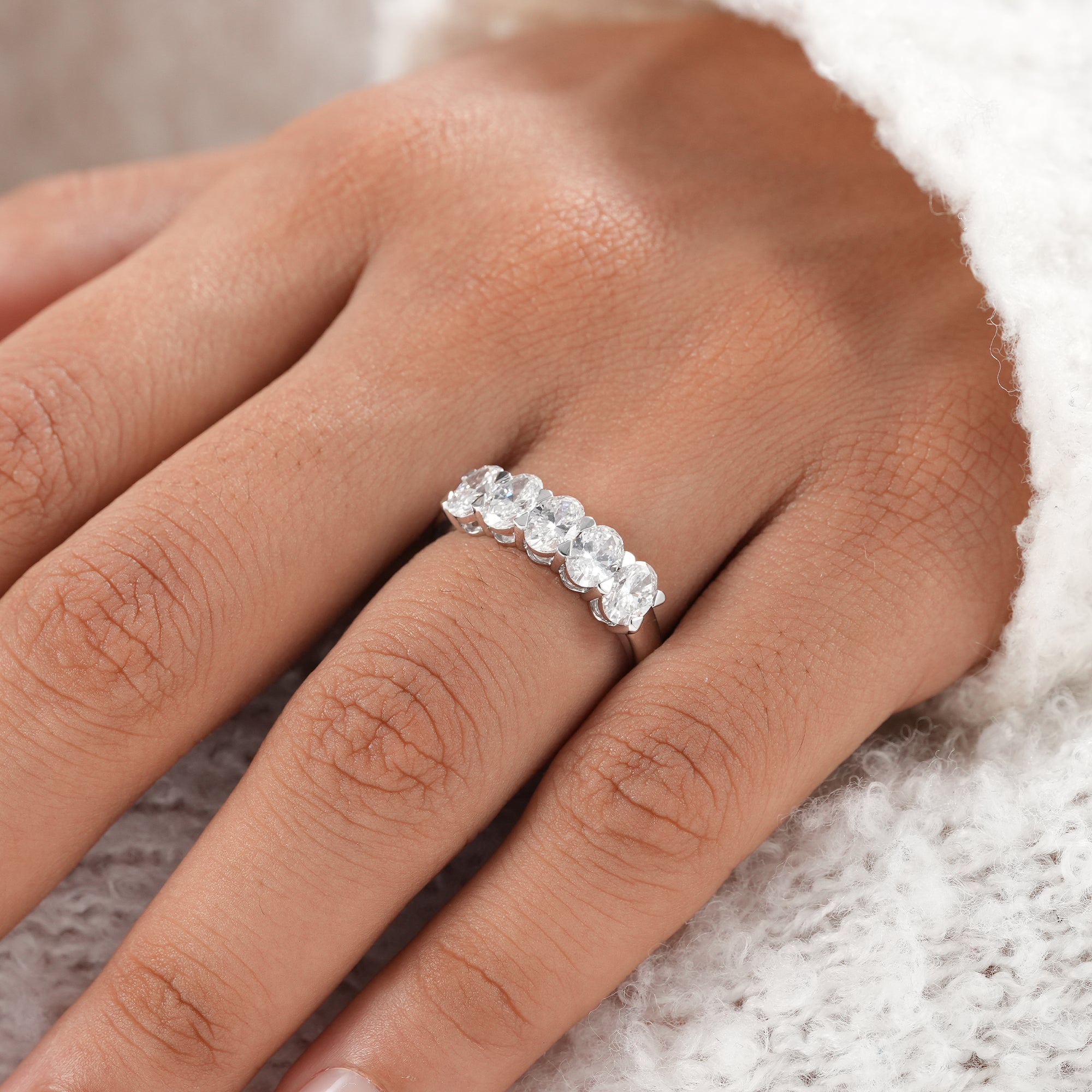 Oval cut lab diamond wedding band in high polish finish.
