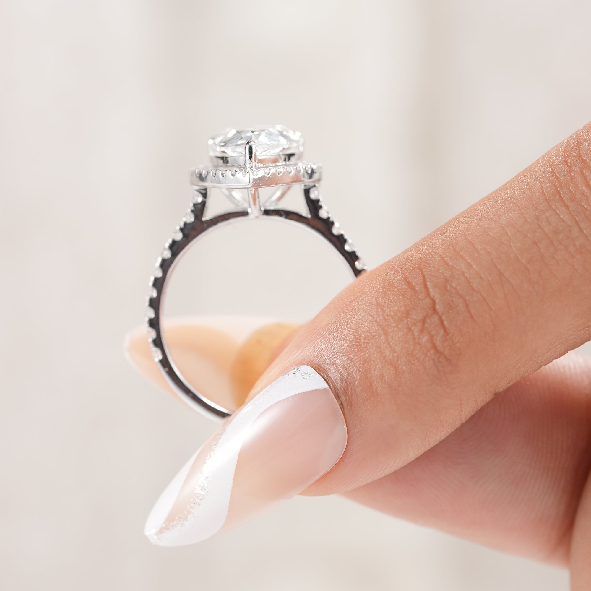Timeless pear diamond ring with halo setting.