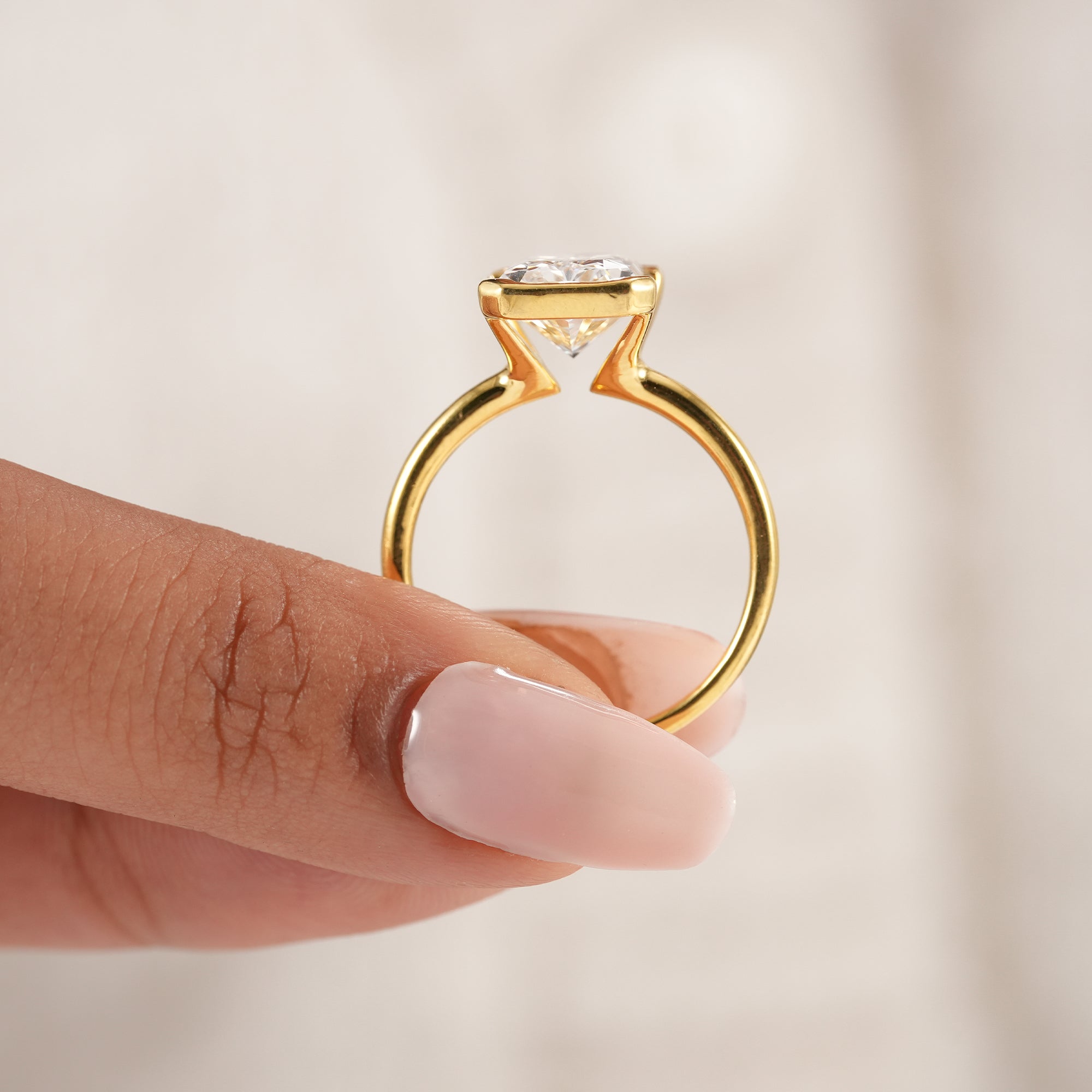 Women's radiant cut lab diamond ring with minimalist styling.