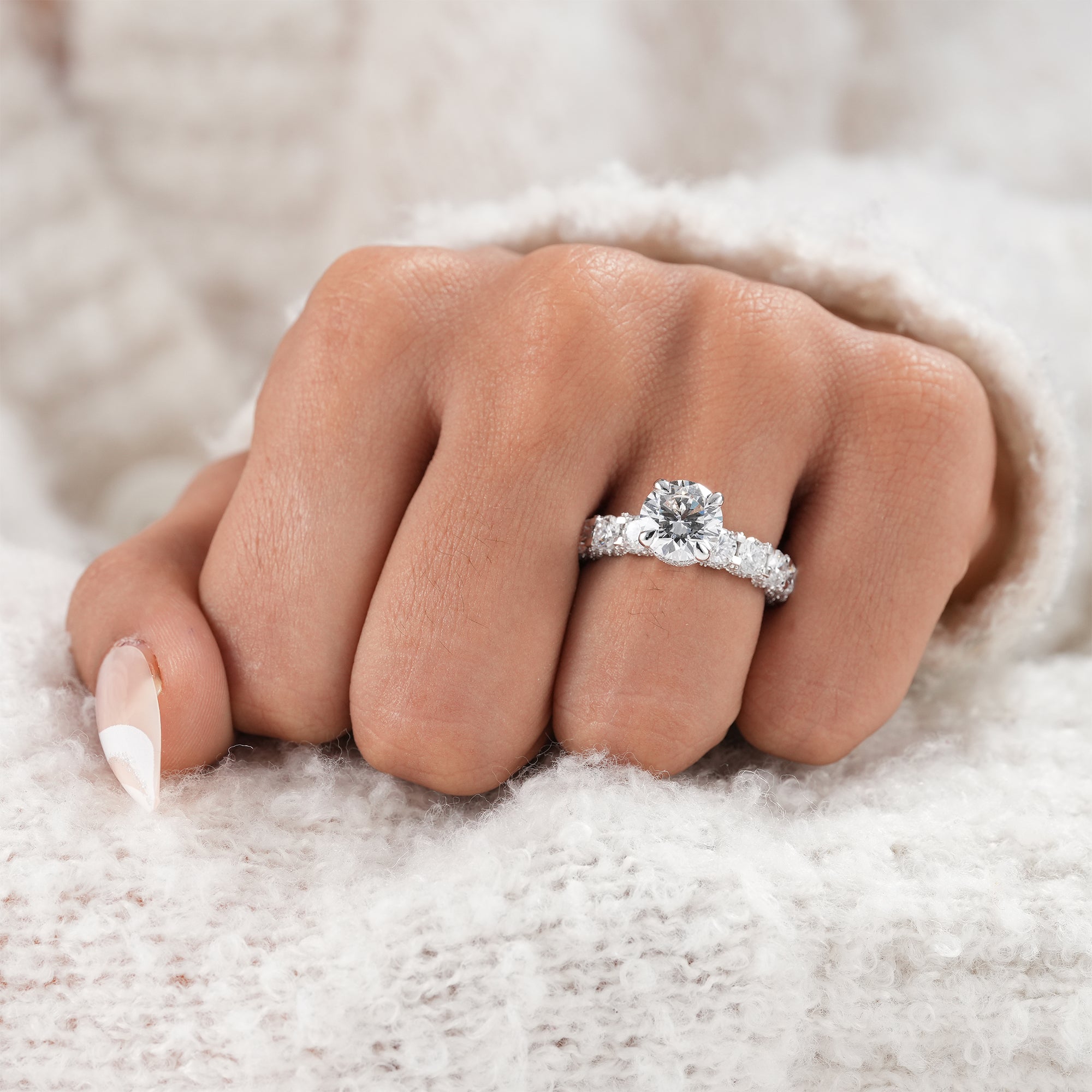 Full diamond detailed band with round brilliant center stone.