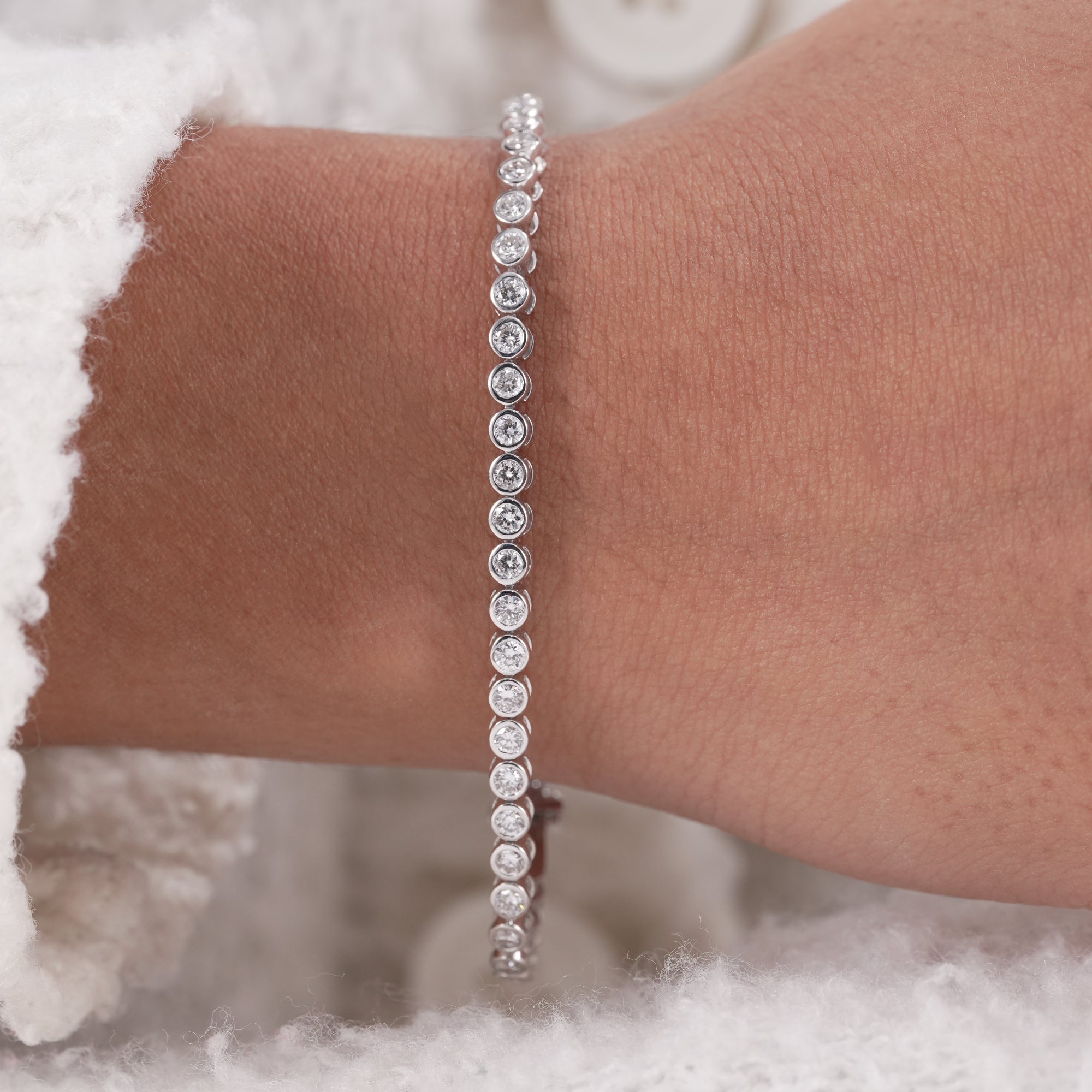 Delicate stacking diamond bracelet with bezel set lab diamonds.