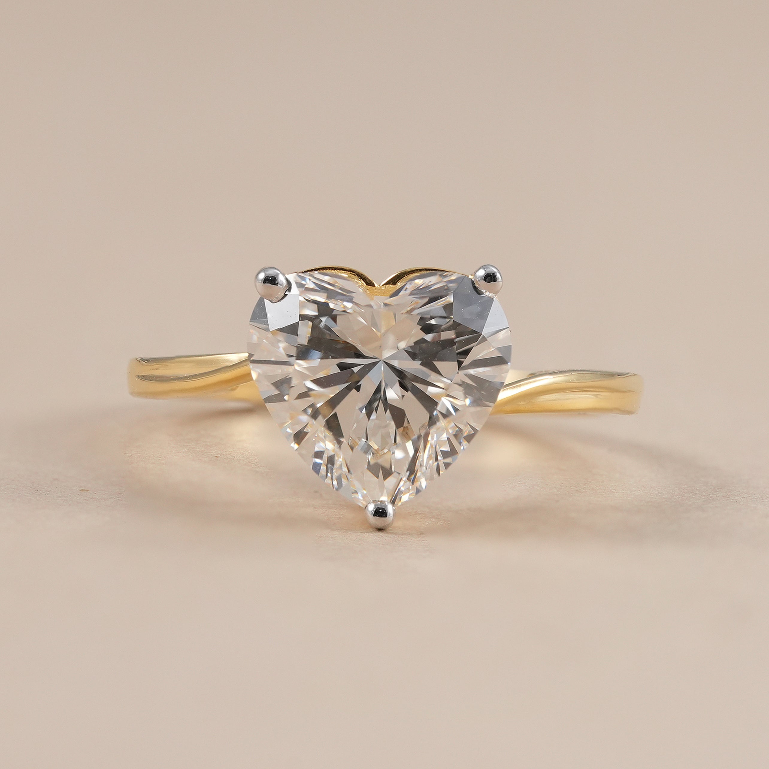 Heart cut lab grown diamond solitaire engagement ring in yellow gold.