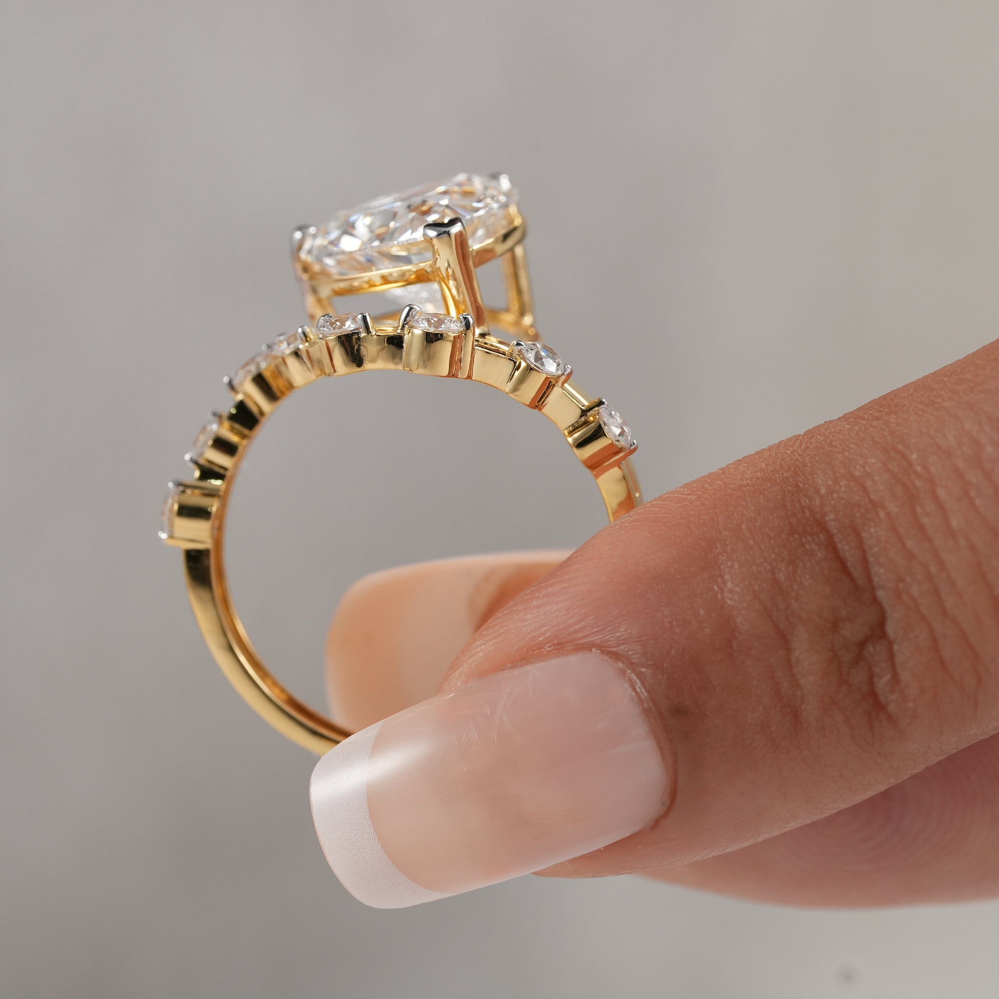 Side view of heart lab diamond ring with open gallery.