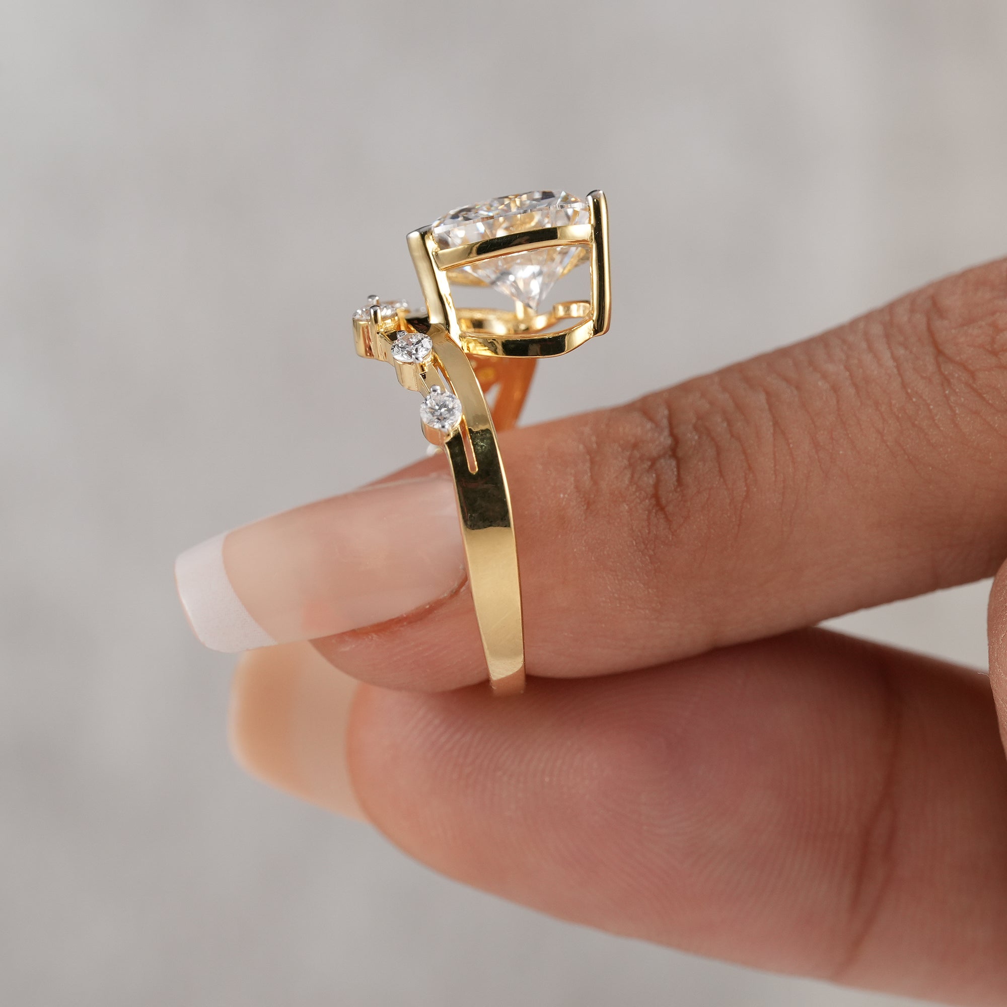 Heart diamond ring featuring curved diamond band and raised setting.