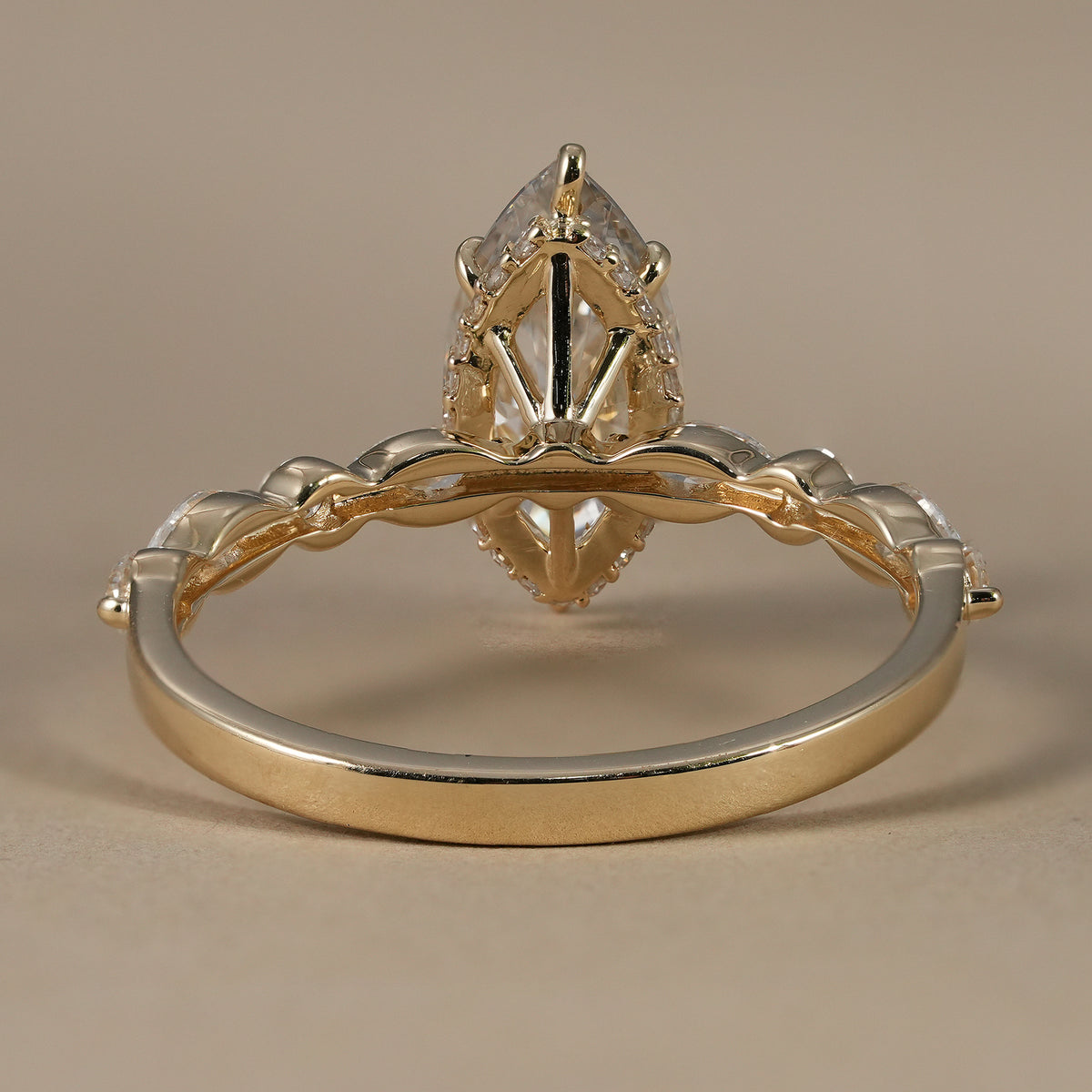 Luxury hidden halo engagement ring with marquise center and round accent lab diamonds.