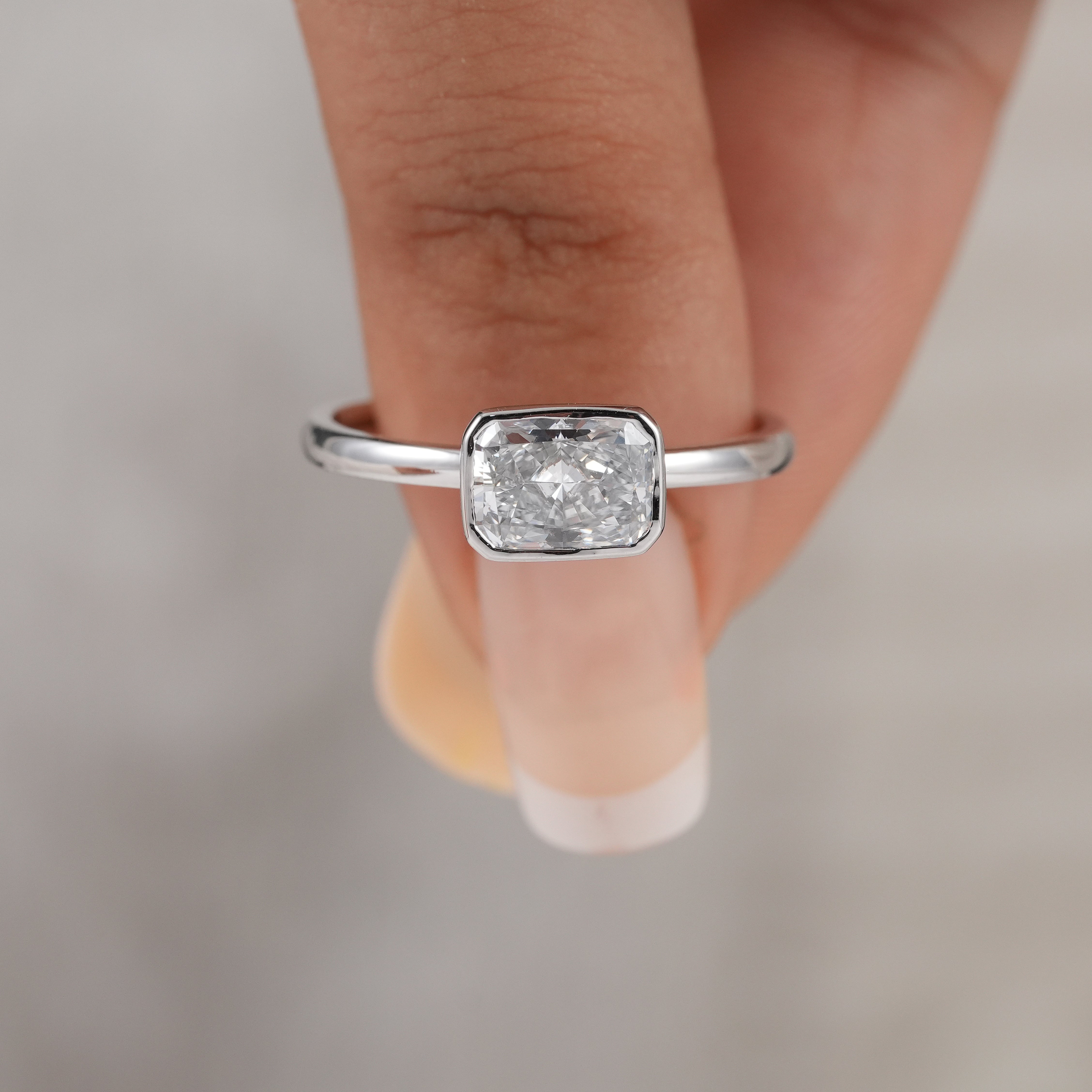 Fine jewelry radiant cut lab diamond ring with sleek bezel setting