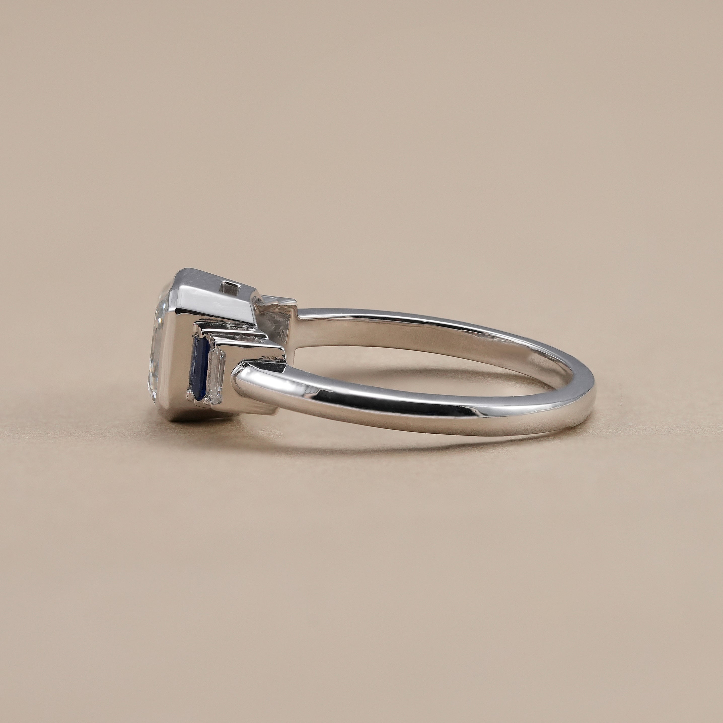 Modern bezel set engagement ring with Asscher cut lab grown diamond.