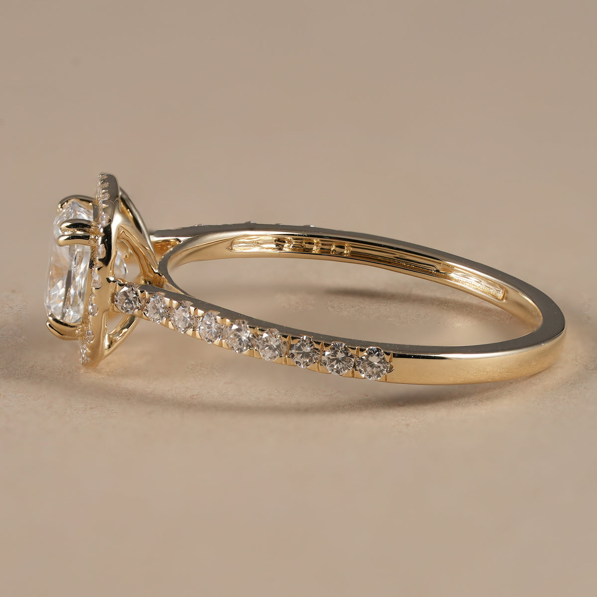 IGI certified cushion lab diamond halo ring featuring brilliant pavé diamonds on a slim gold band.