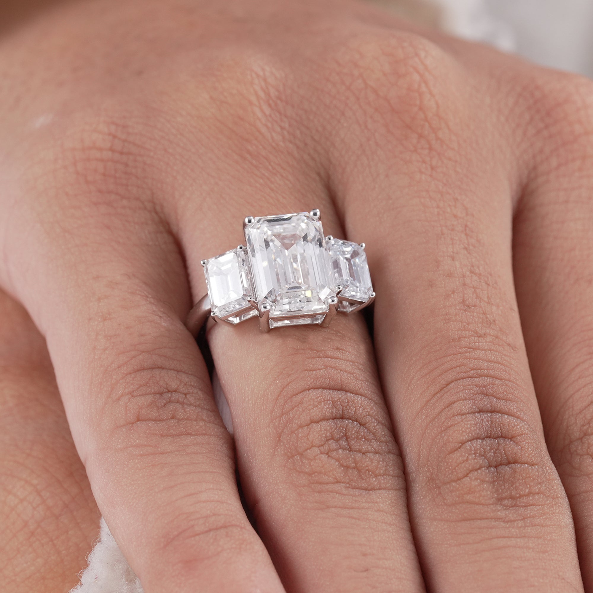 Classic three stone engagement ring with emerald cut diamonds