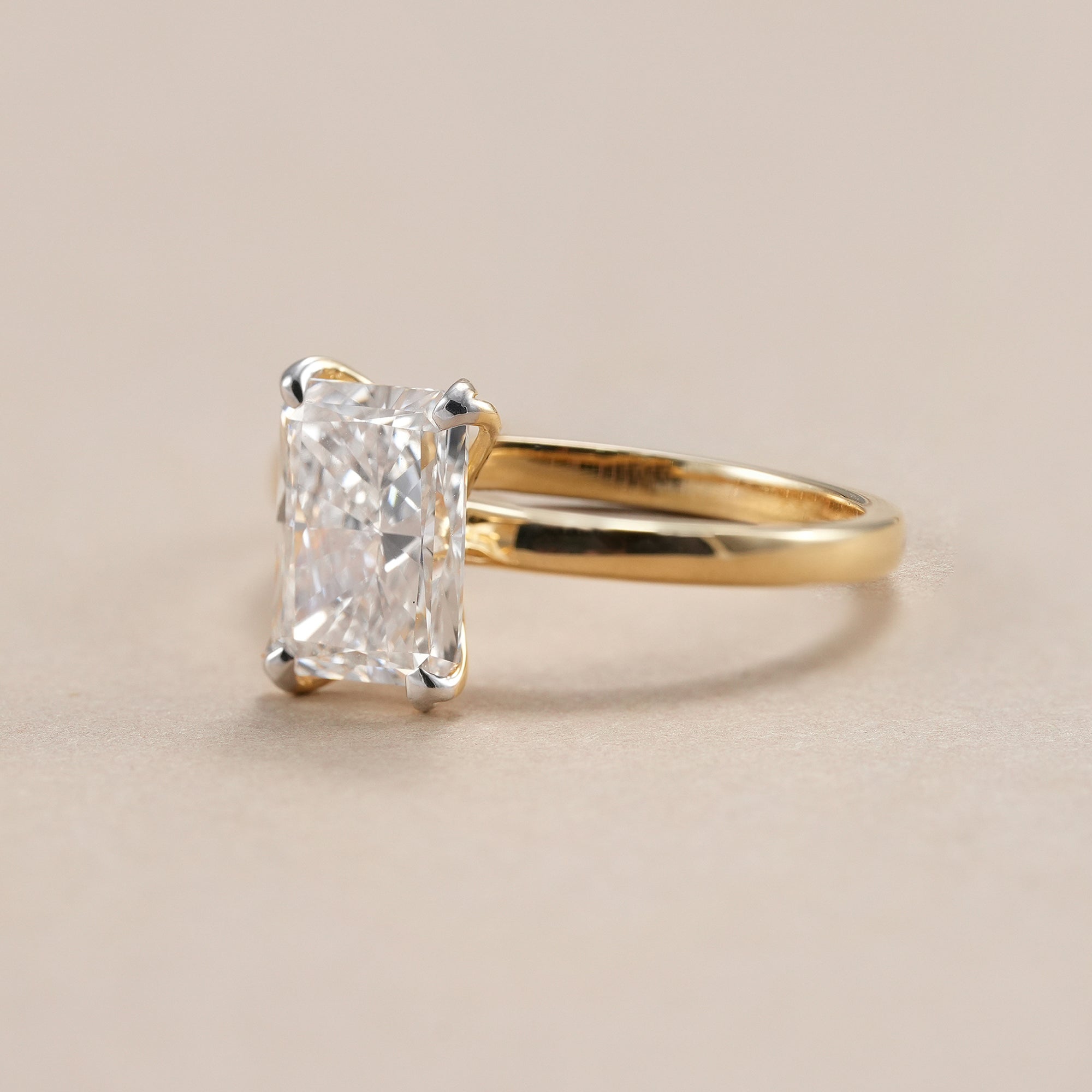 Elegant radiant cut lab grown diamond engagement ring in classic solitaire setting.