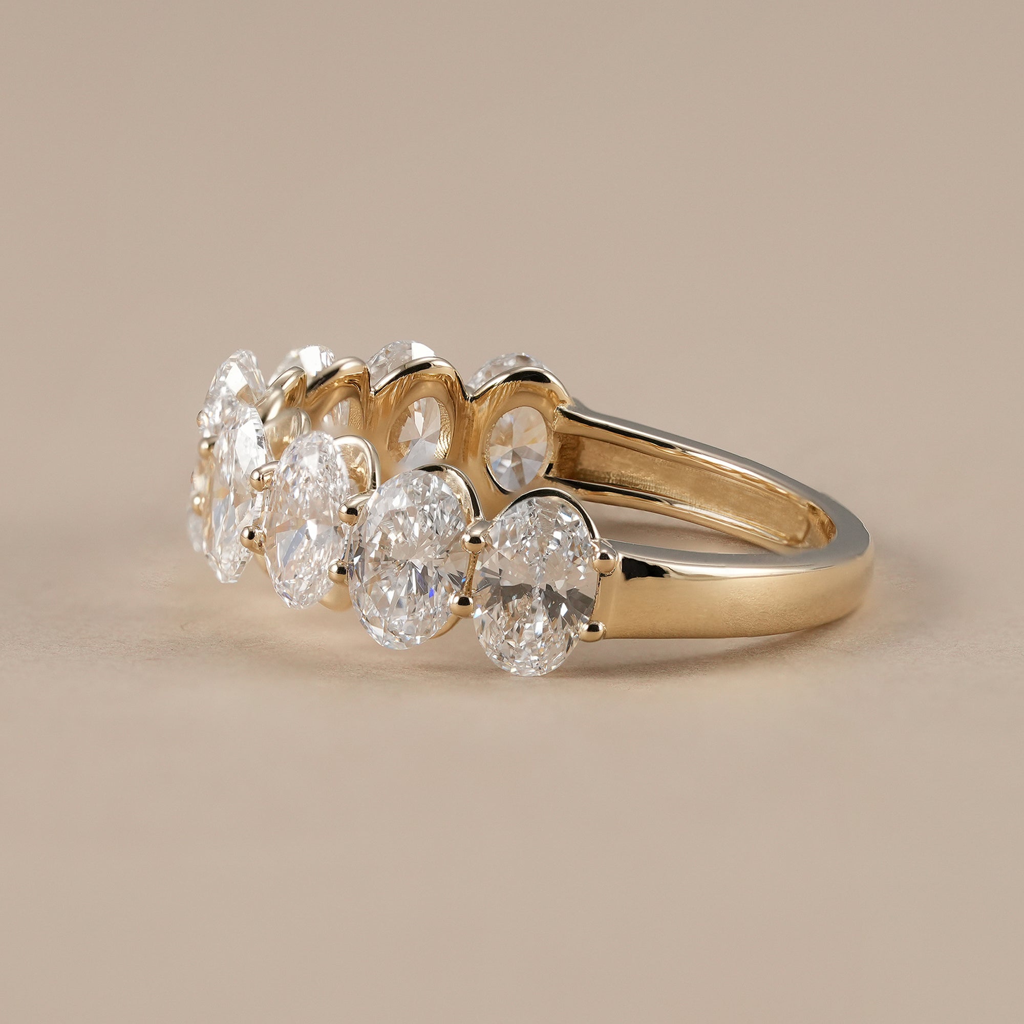 Shared prong oval diamond anniversary band