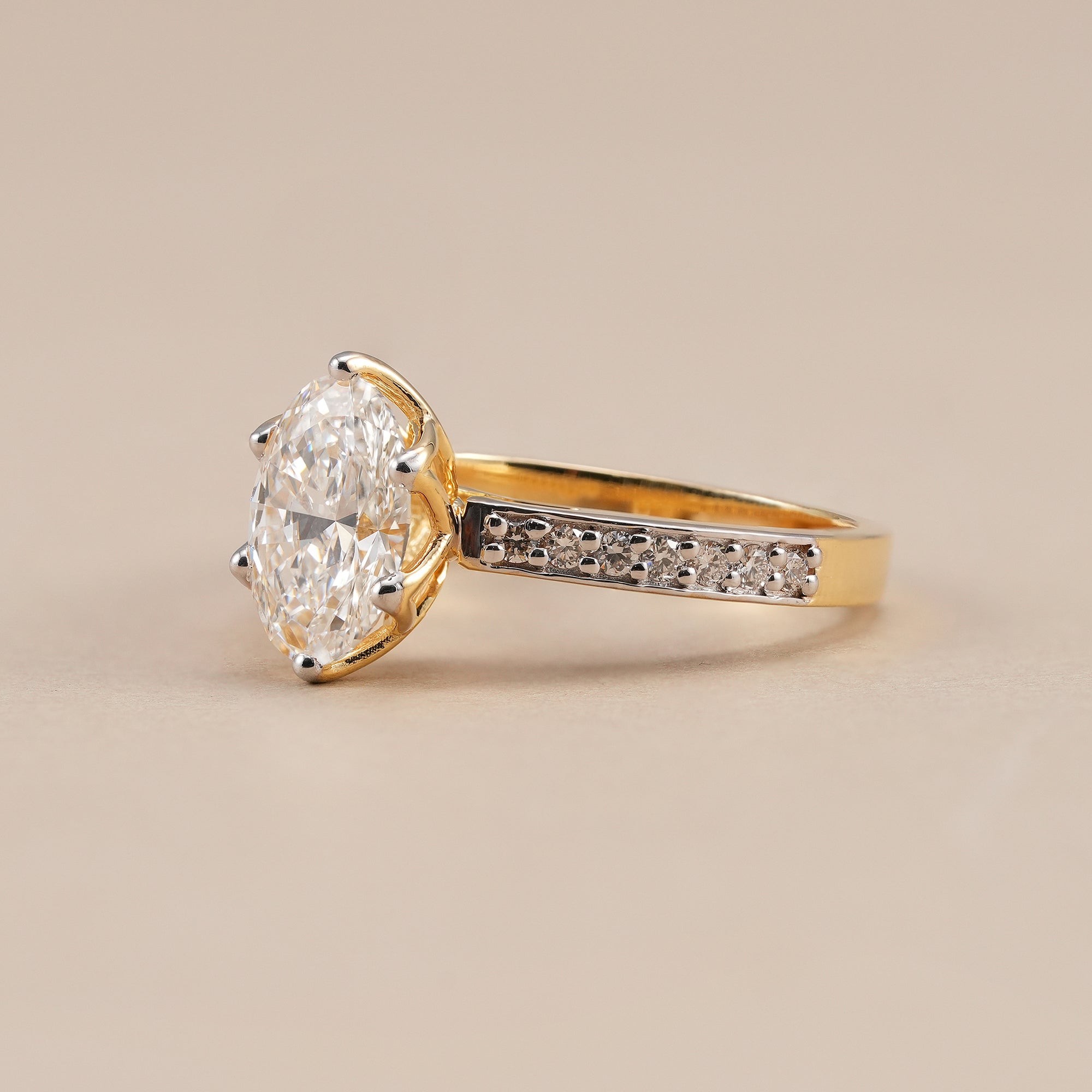 Elegant oval diamond solitaire ring with sparkling pavé band