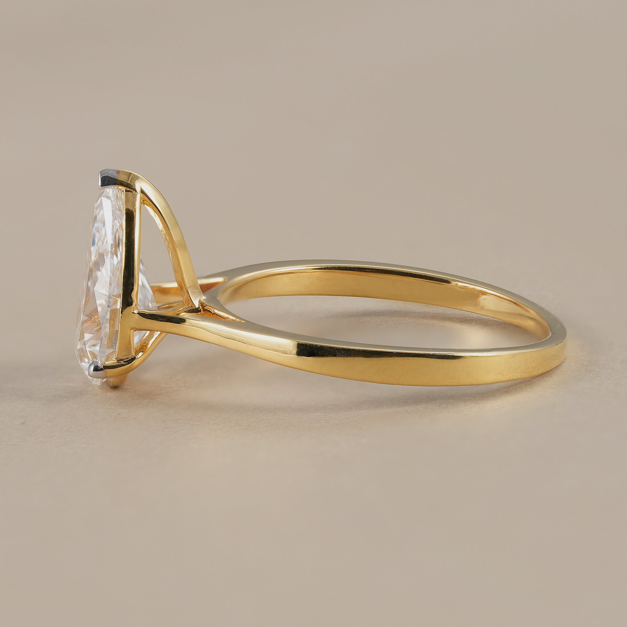 Pear solitaire engagement ring with cathedral style setting