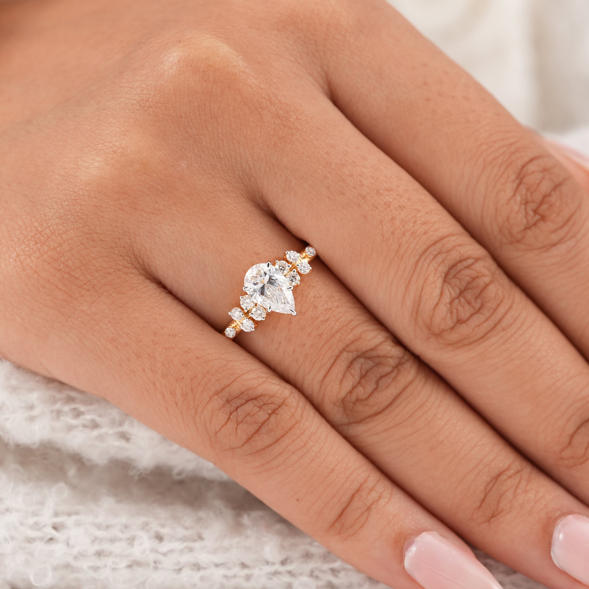 Pear cut lab diamond ring with sparkling round accent diamonds