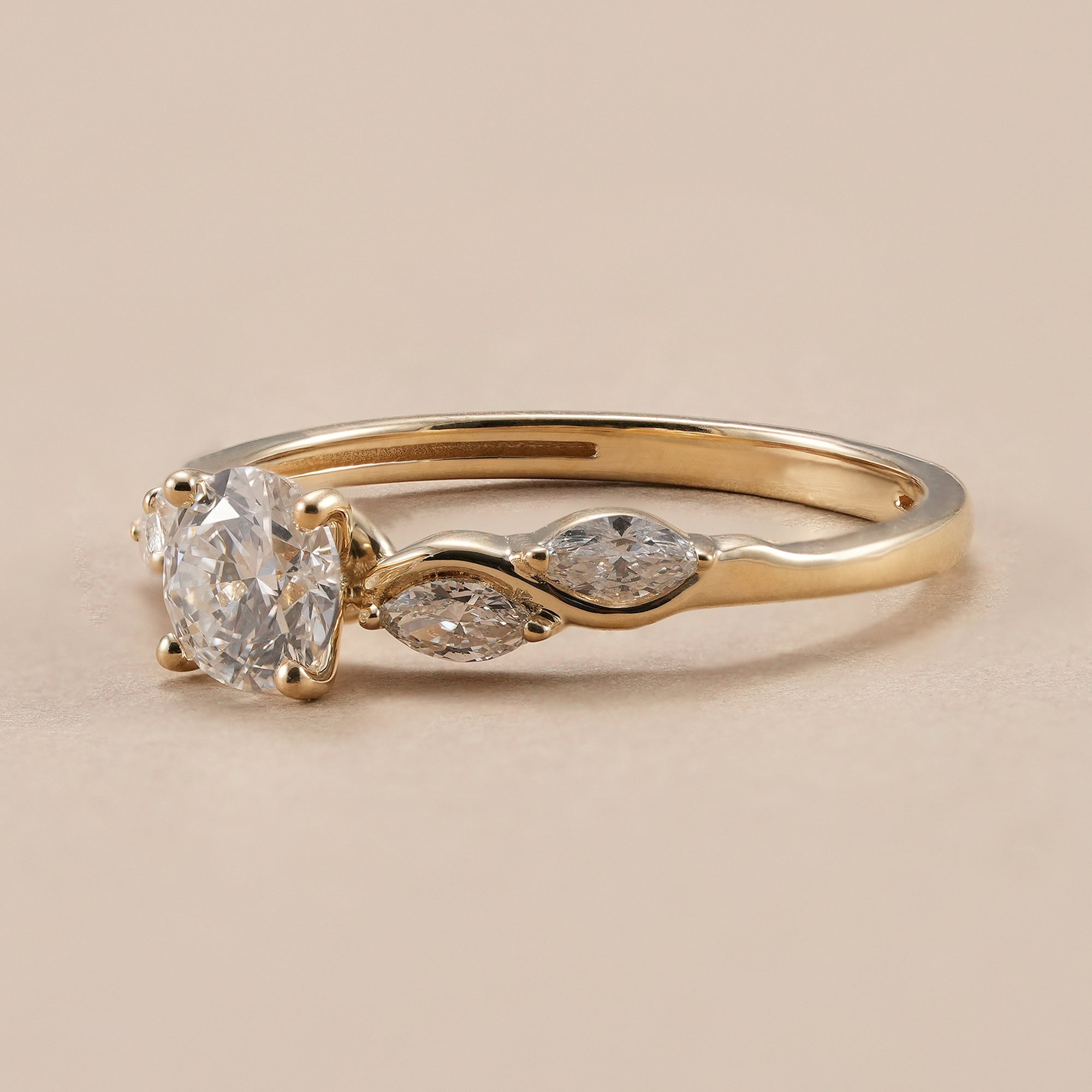 IGI certified round diamond solitaire ring with marquise side diamonds.