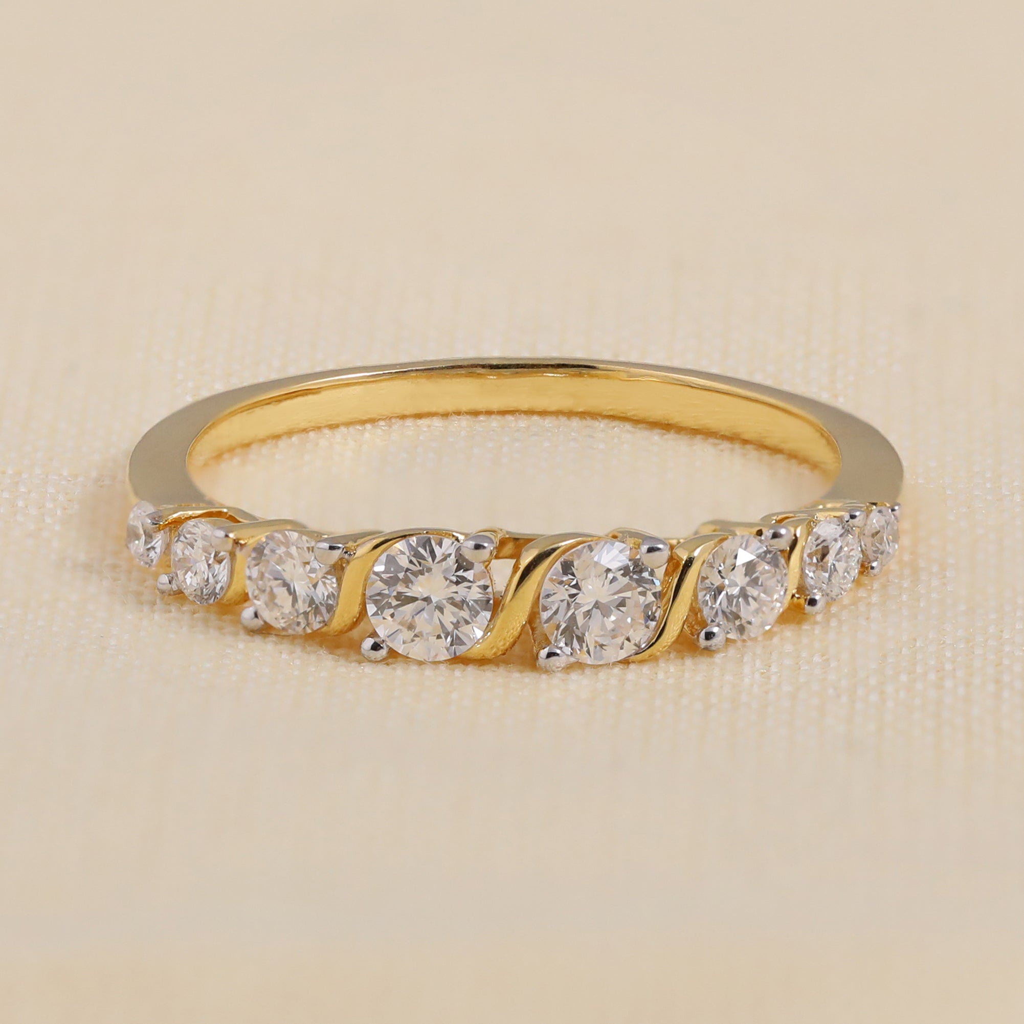 Elegant gold ring featuring round diamonds in a wave-style setting for a classic look.